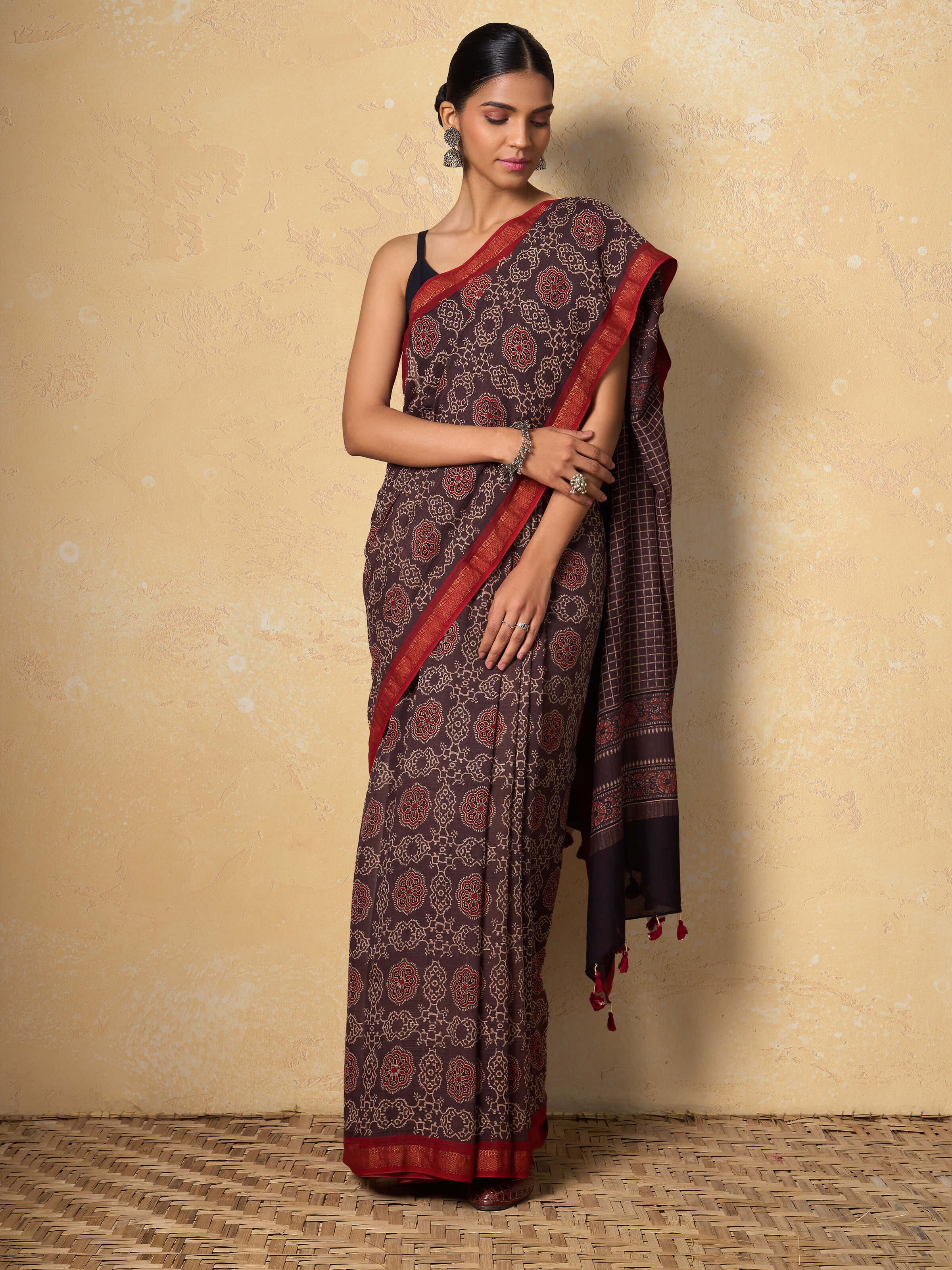 Lifestyle view of model in maroon Ajrakh Maheshwari saree with blouse