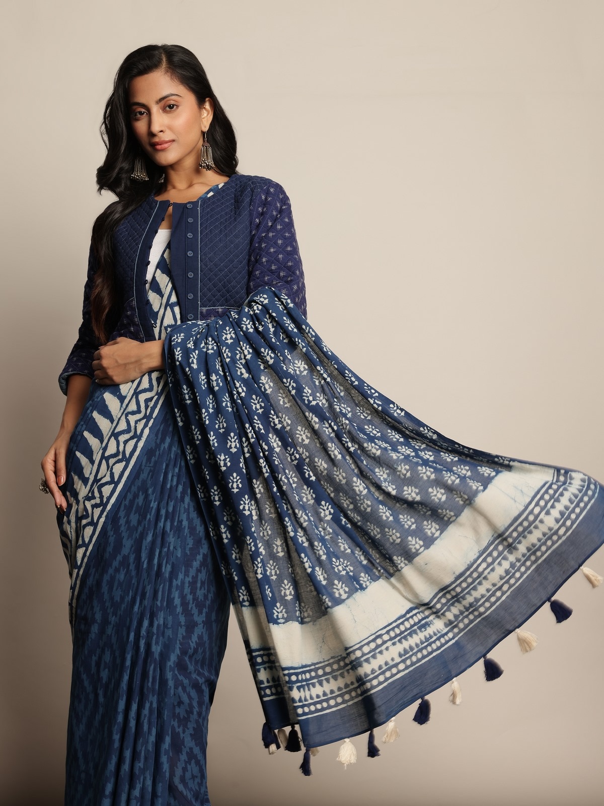 Front side pose of model highlighting the elegant drape and floral Dabu block motifs on blue and white cotton saree.