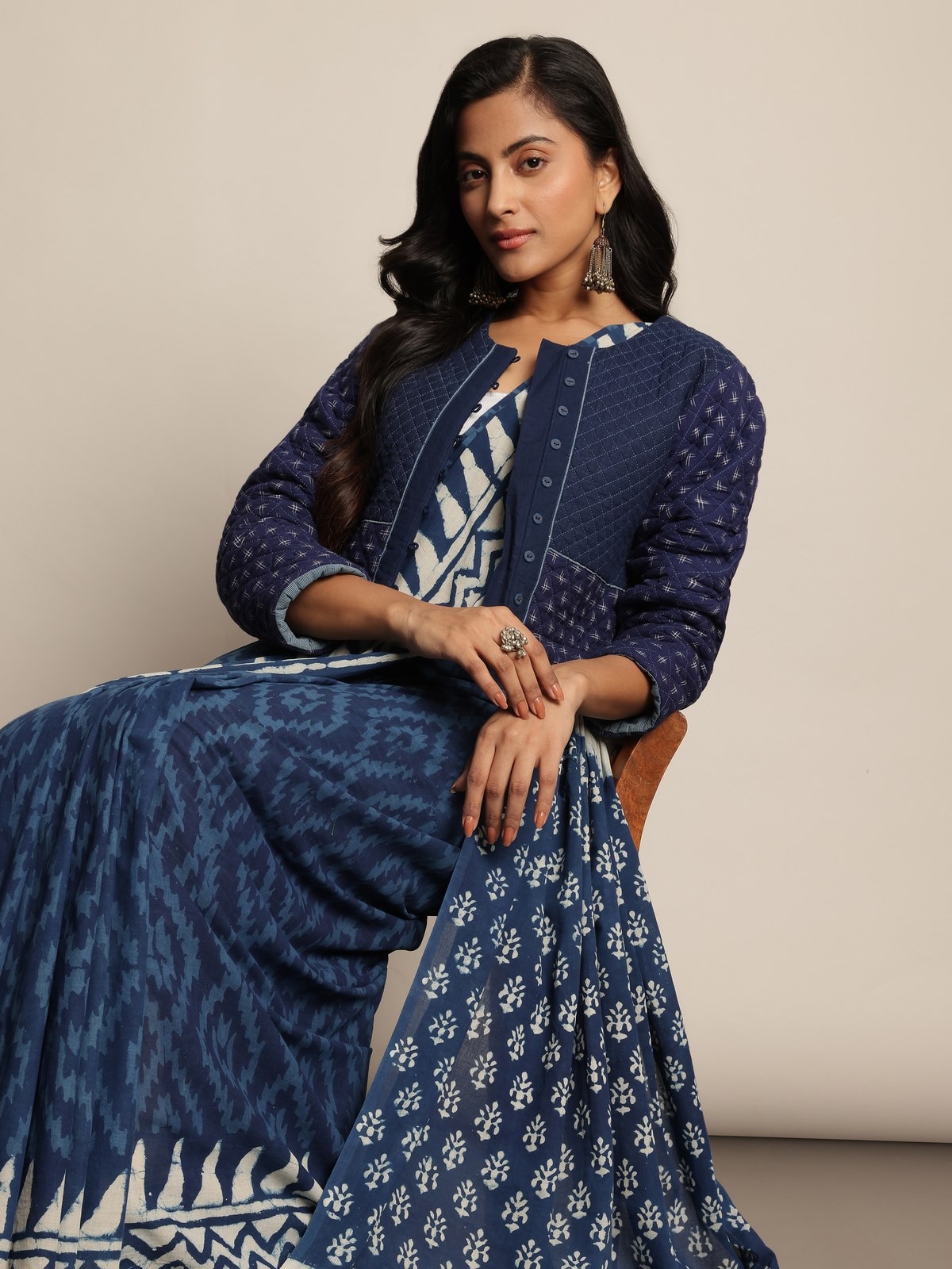 Close-up view focusing on the intricate Dabu printing and soft blue and white cotton weave of the saree.