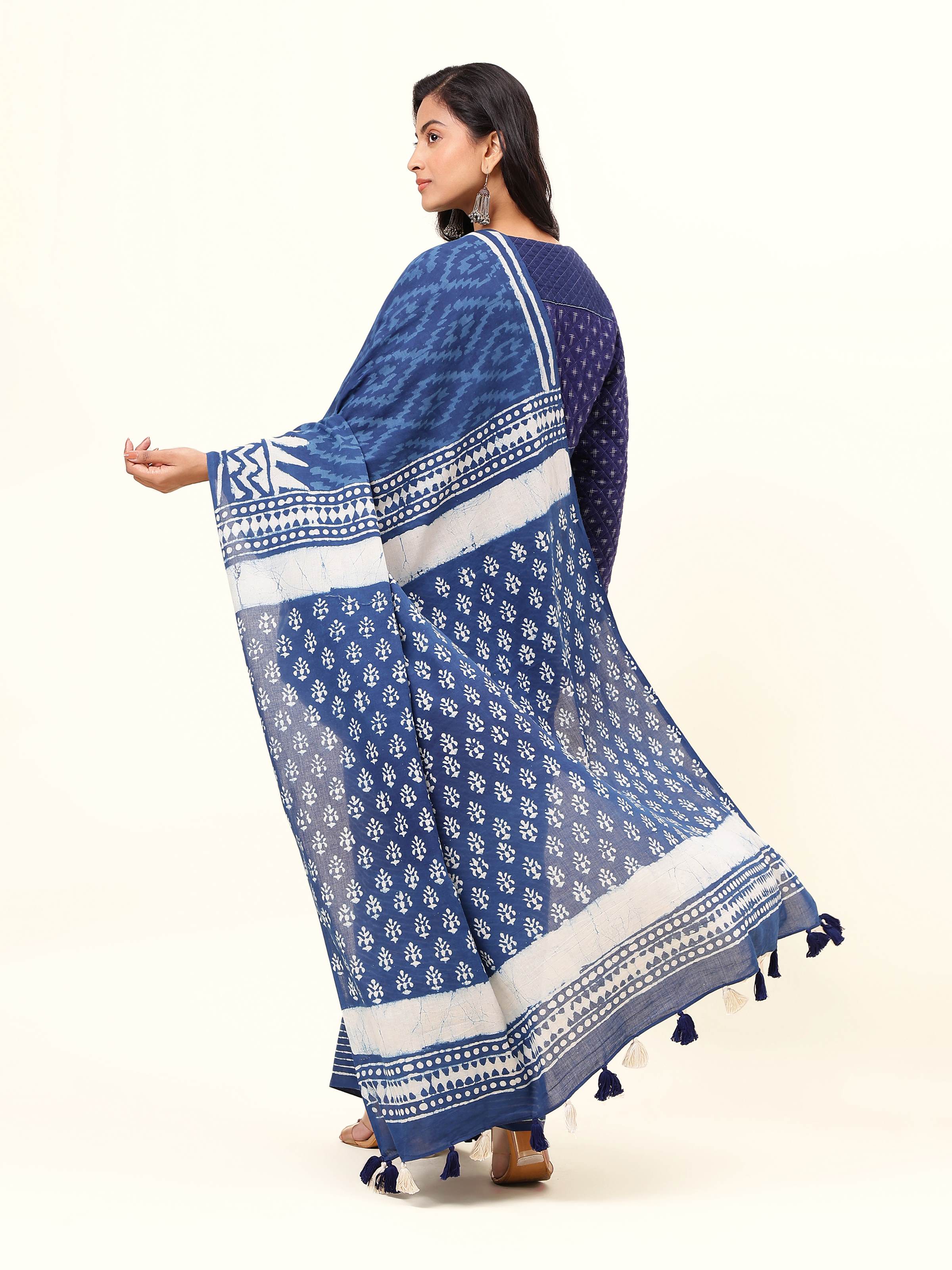 Back view of the blue & white Dabu printed saree showcasing the pallu design and fluid drape.