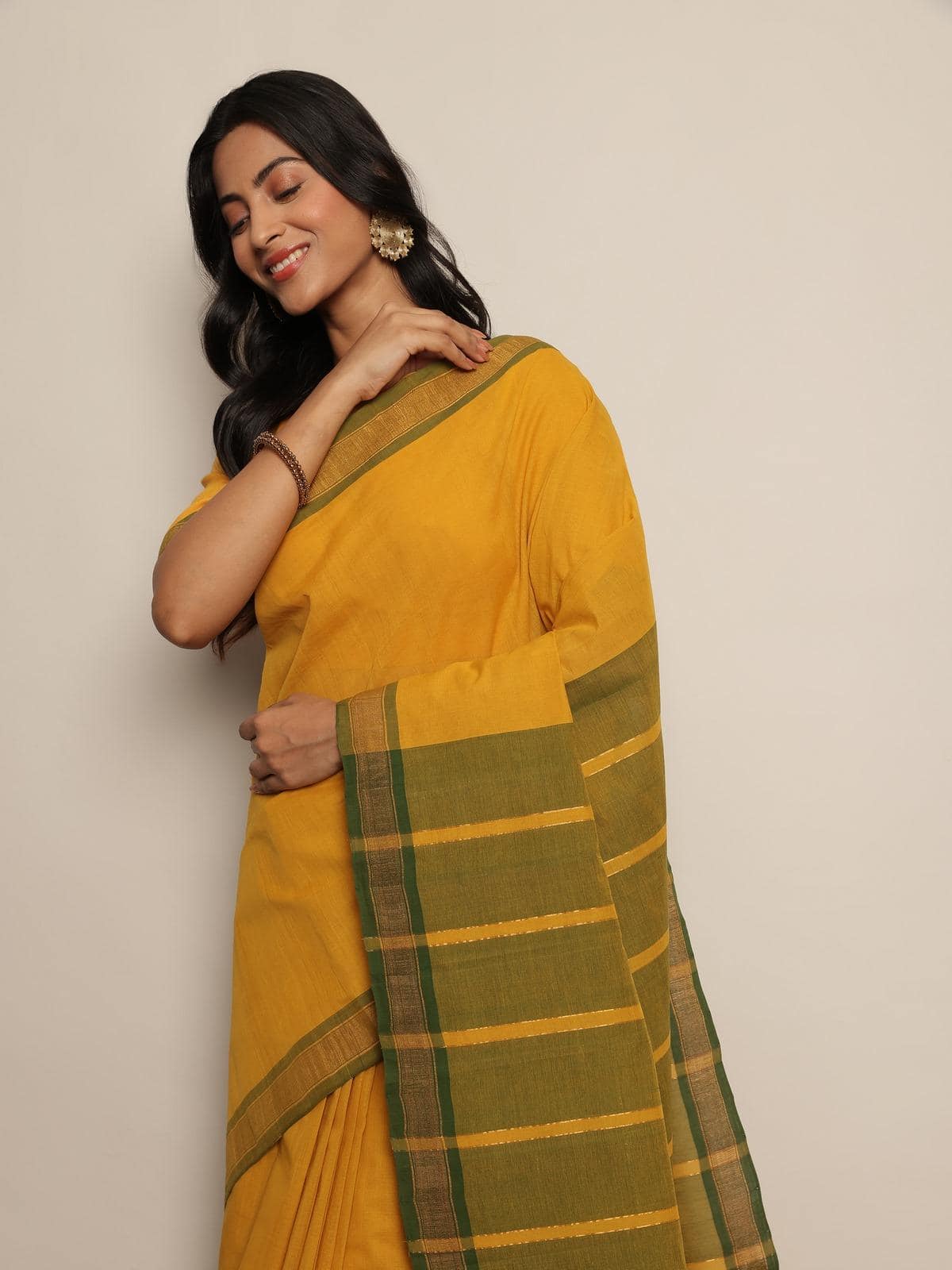 Side view of Mustard Cotton Mangalgiri Saree showing fabric fall and border design.