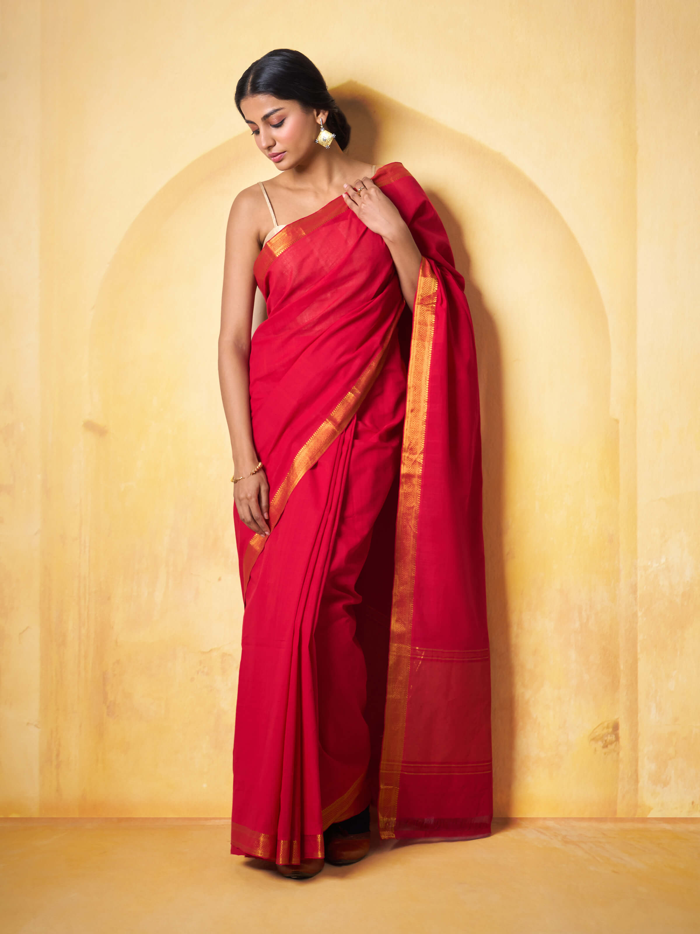 Lifestyle view of red Mangalgiri cotton saree styled traditionally with blouse