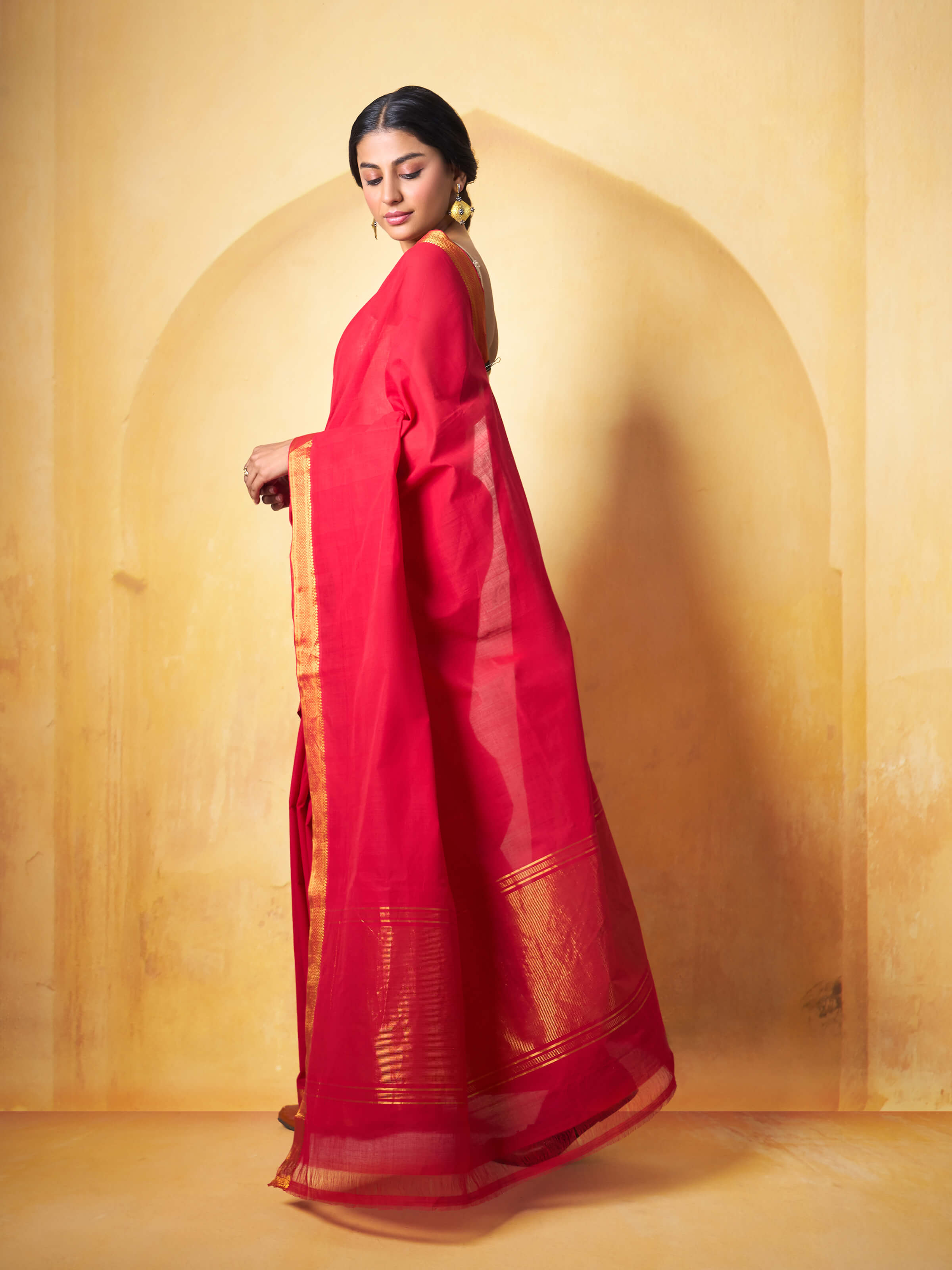 Angled view showing pallu texture and zari border detailing