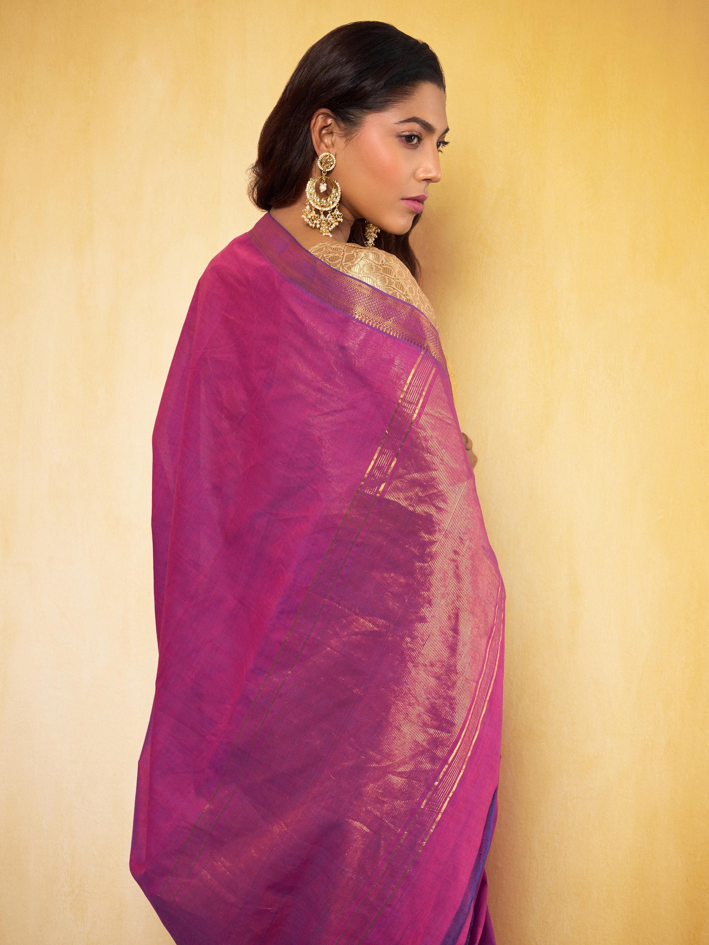Angled view of purple cotton saree showcasing contrast border