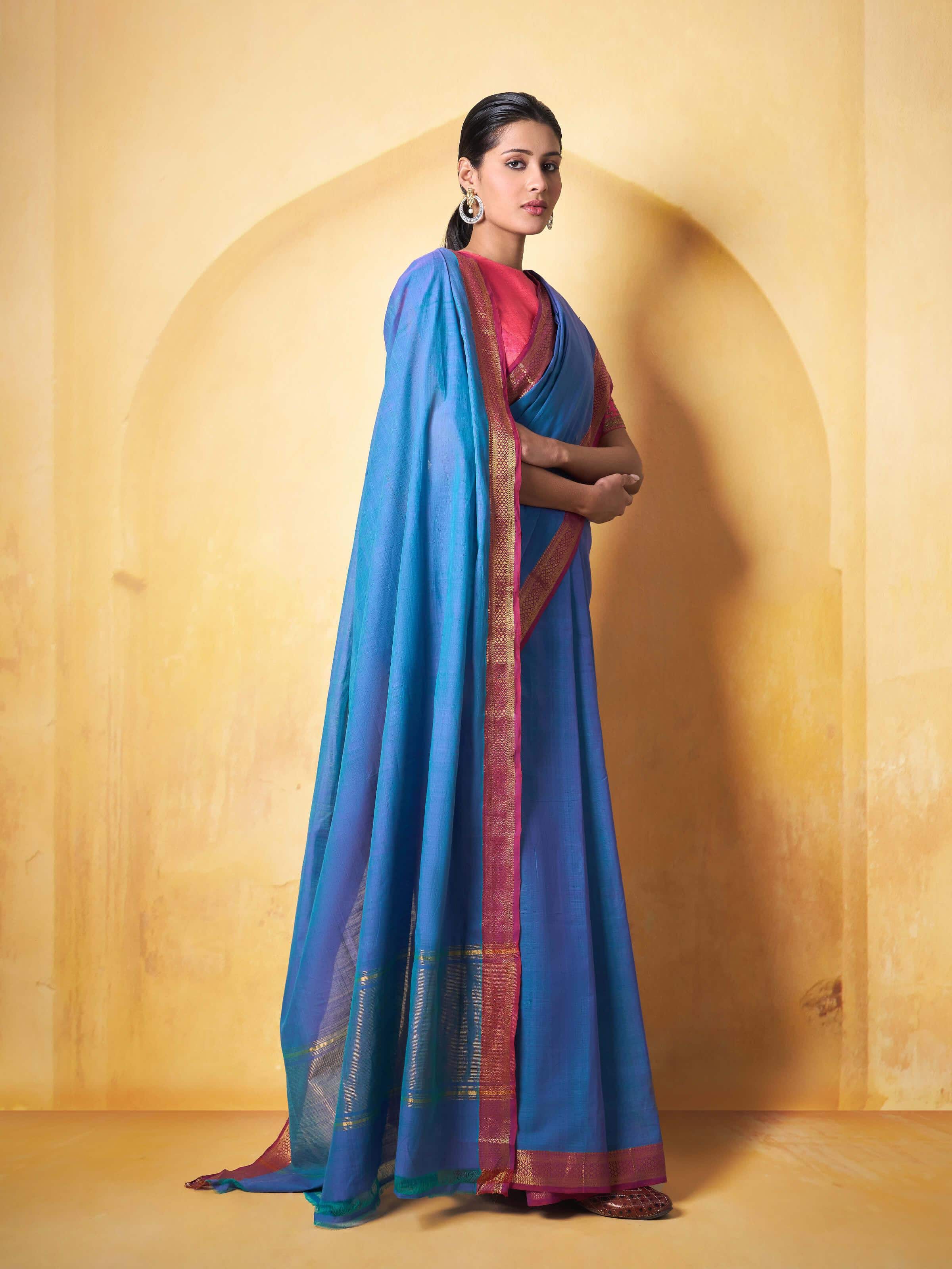 Angled view of cotton Mangalgiri saree showing contrast border and pink pallu detailing.