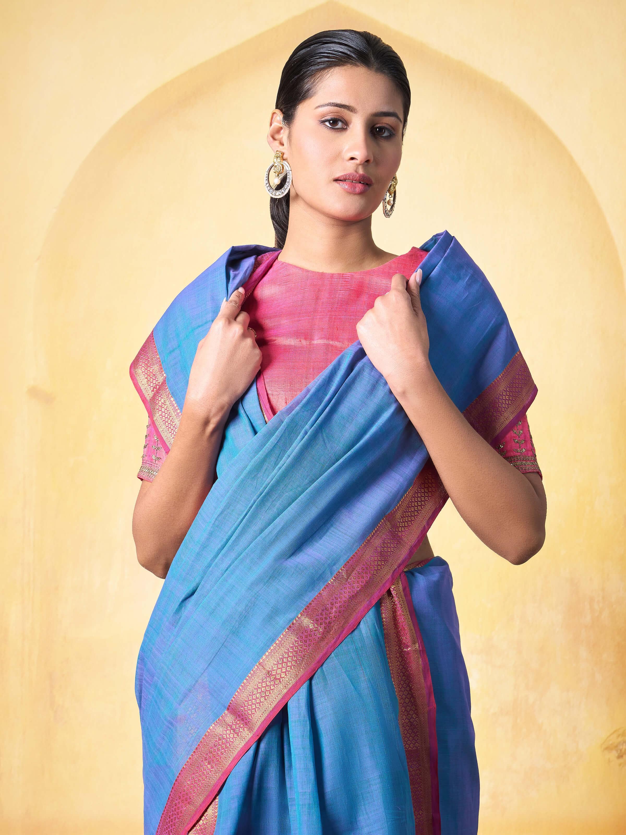 Close-up of blue and pink Mangalgiri saree highlighting weave and color transitions.