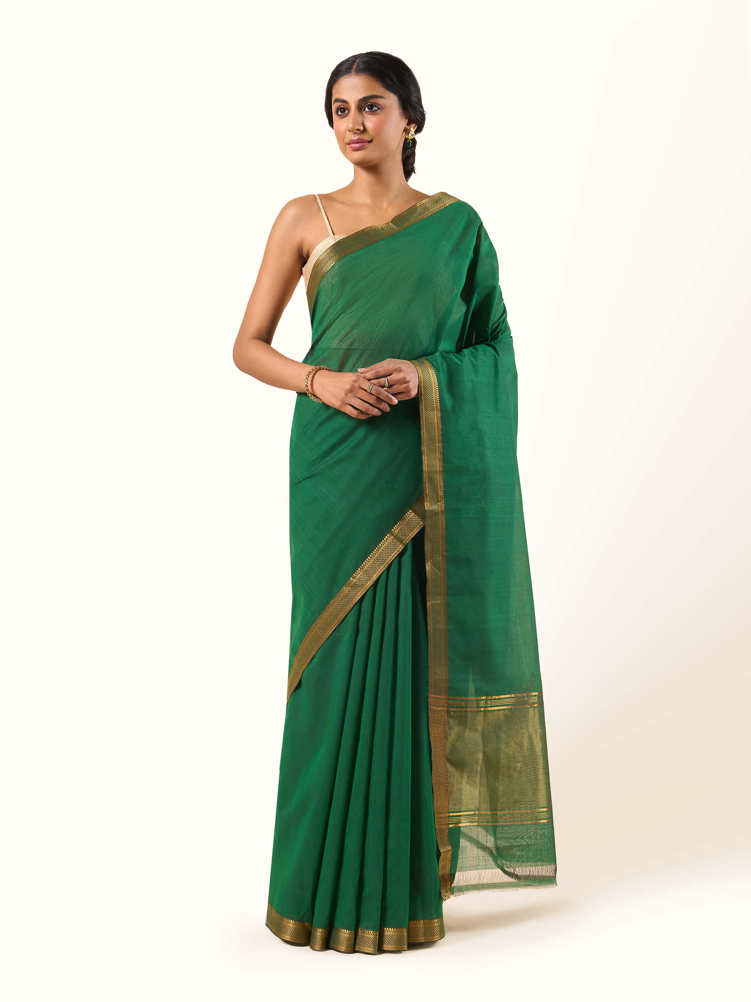 Front view of dark green cotton Mangalgiri saree showcasing rich texture and traditional weaving.