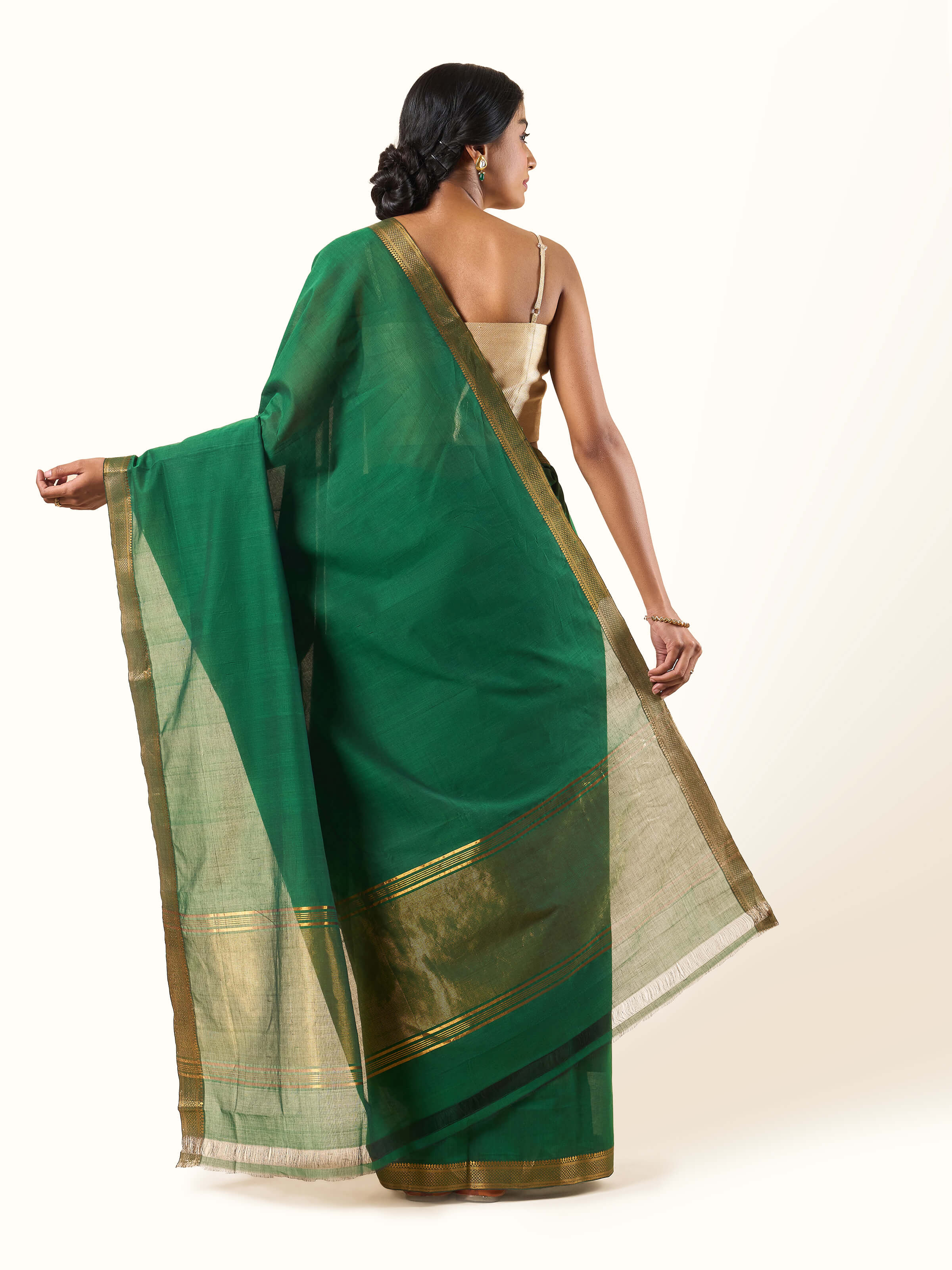 Back view of dark green cotton Mangalgiri saree displaying overall drape and craftsmanship.