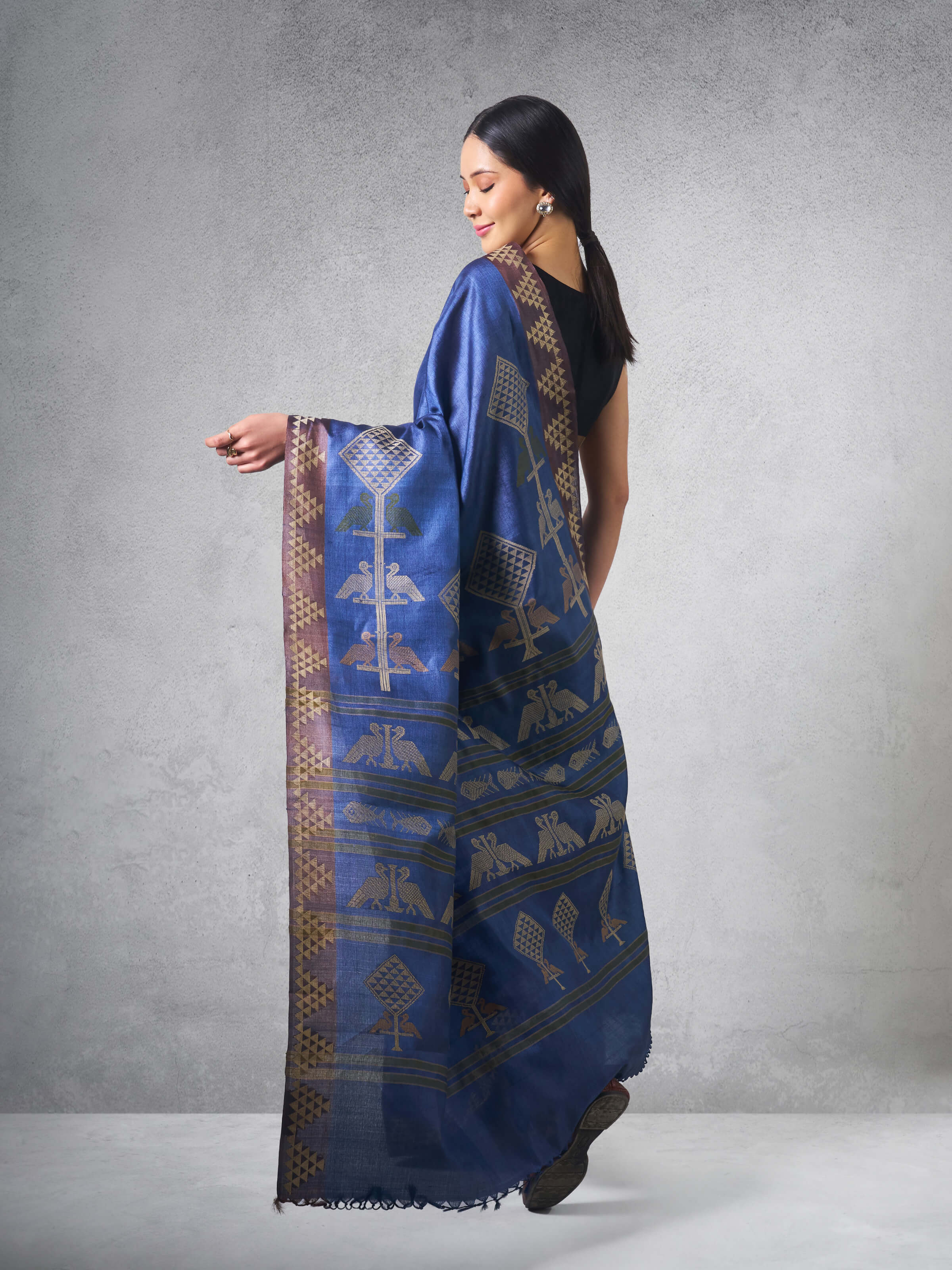 Lifestyle view featuring the Tussar silk saree worn with traditional jewelry.