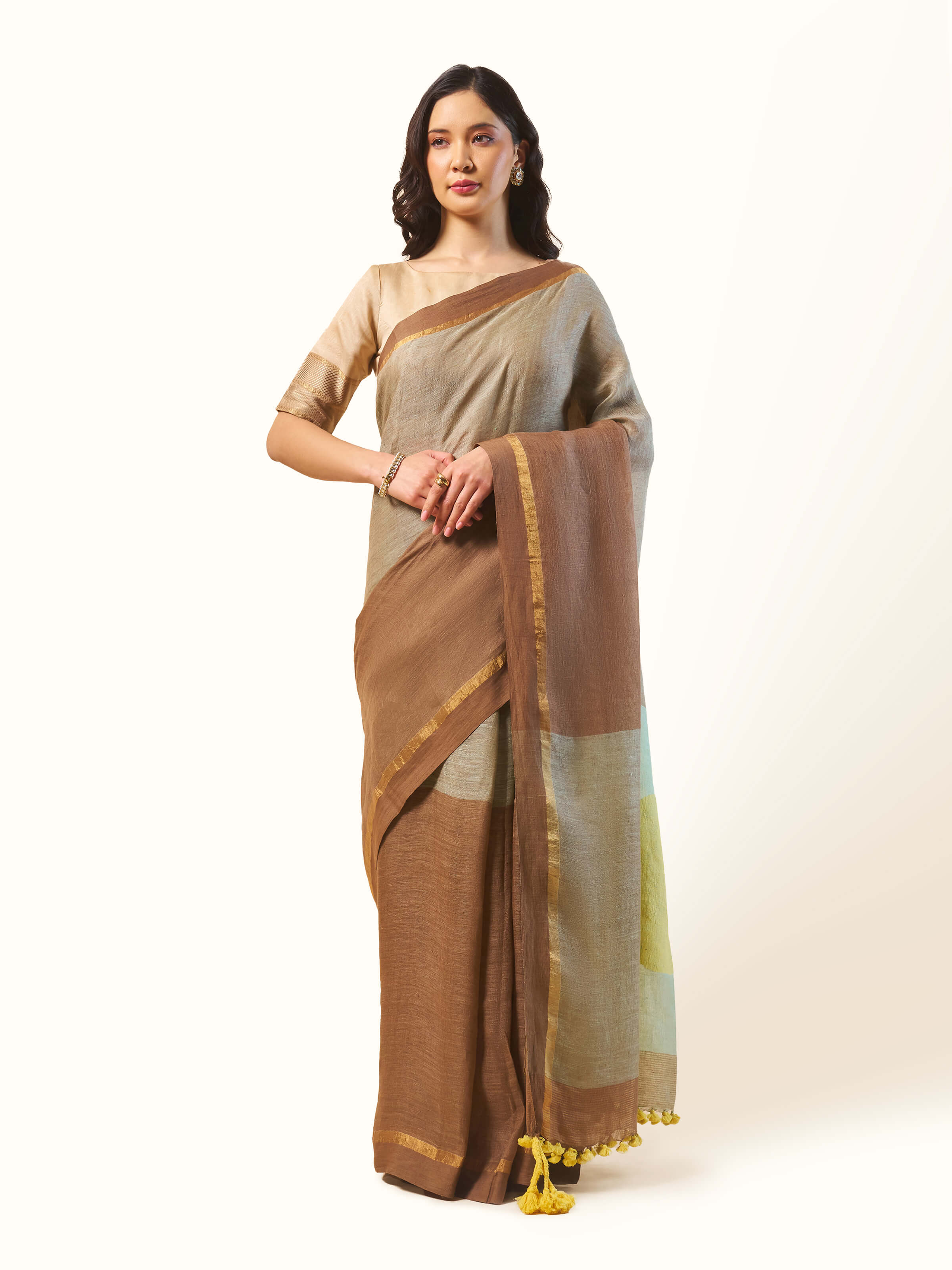 Front view of beige linen cotton saree with smooth texture and natural finish.