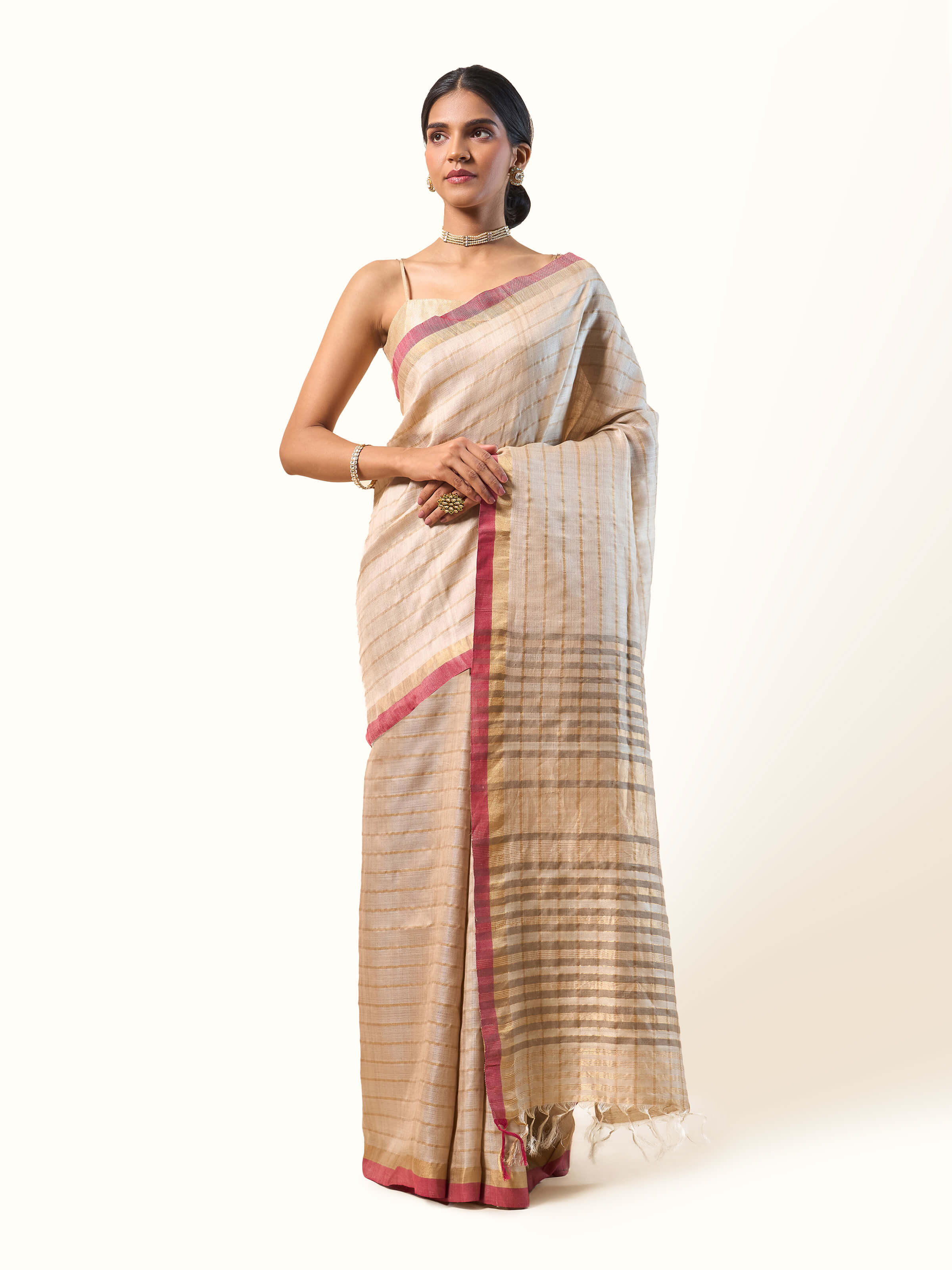 Front view of beige and pink Tussar silk saree featuring fine zari work.