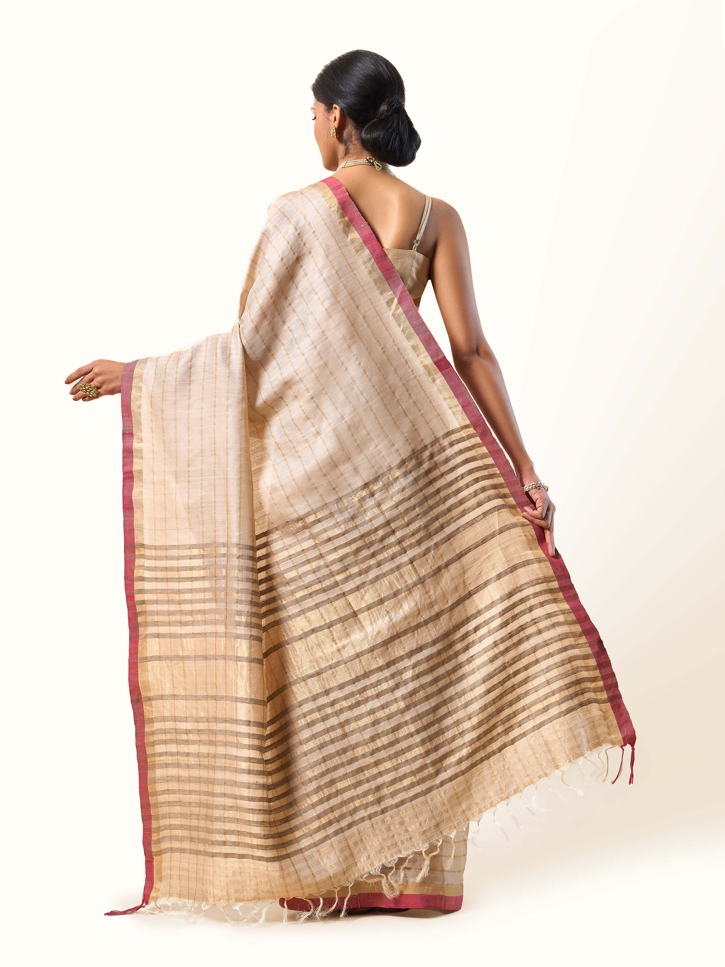 Back view capturing pallu and border design with zari finish.
