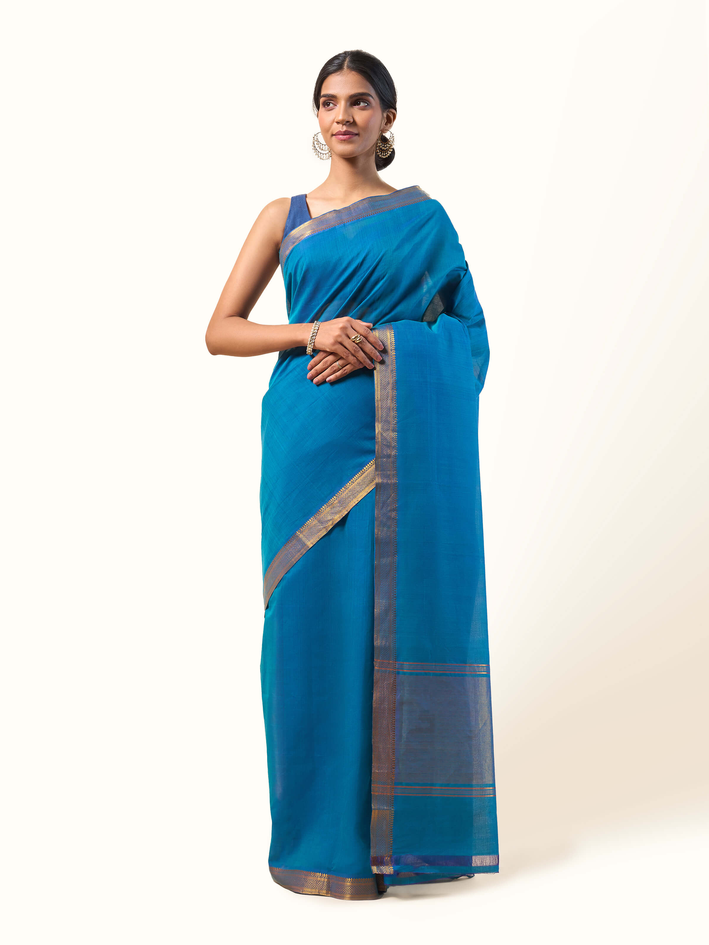 Front view capturing the elegance of the indigo and golden cotton Mangalgiri saree, radiating traditional grace.