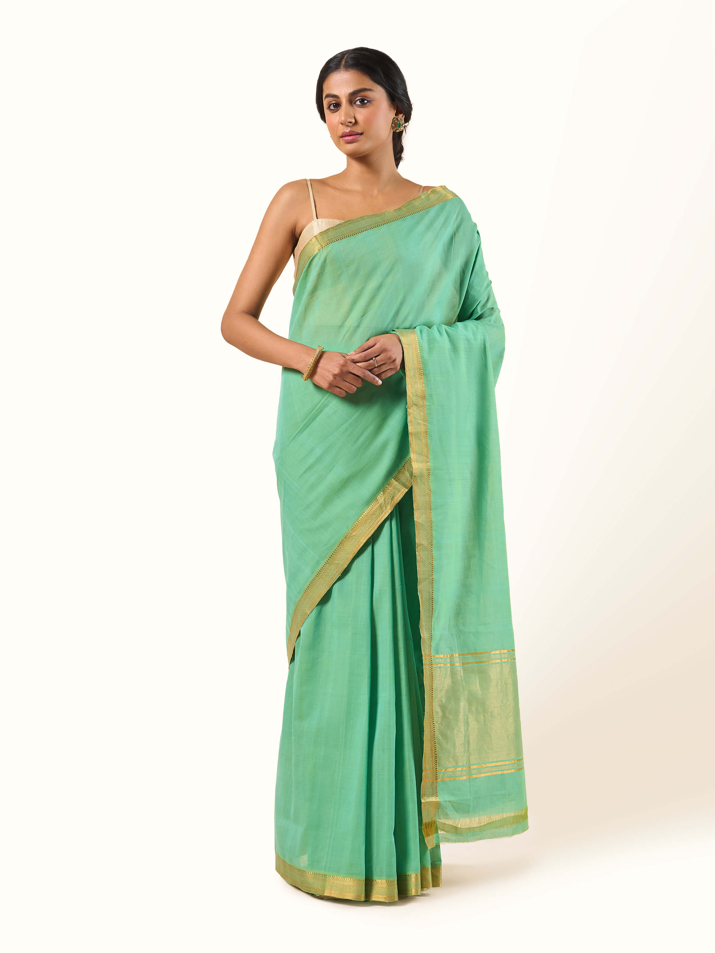 Front view displaying the fresh green cotton Mangalgiri saree with zari border accents.