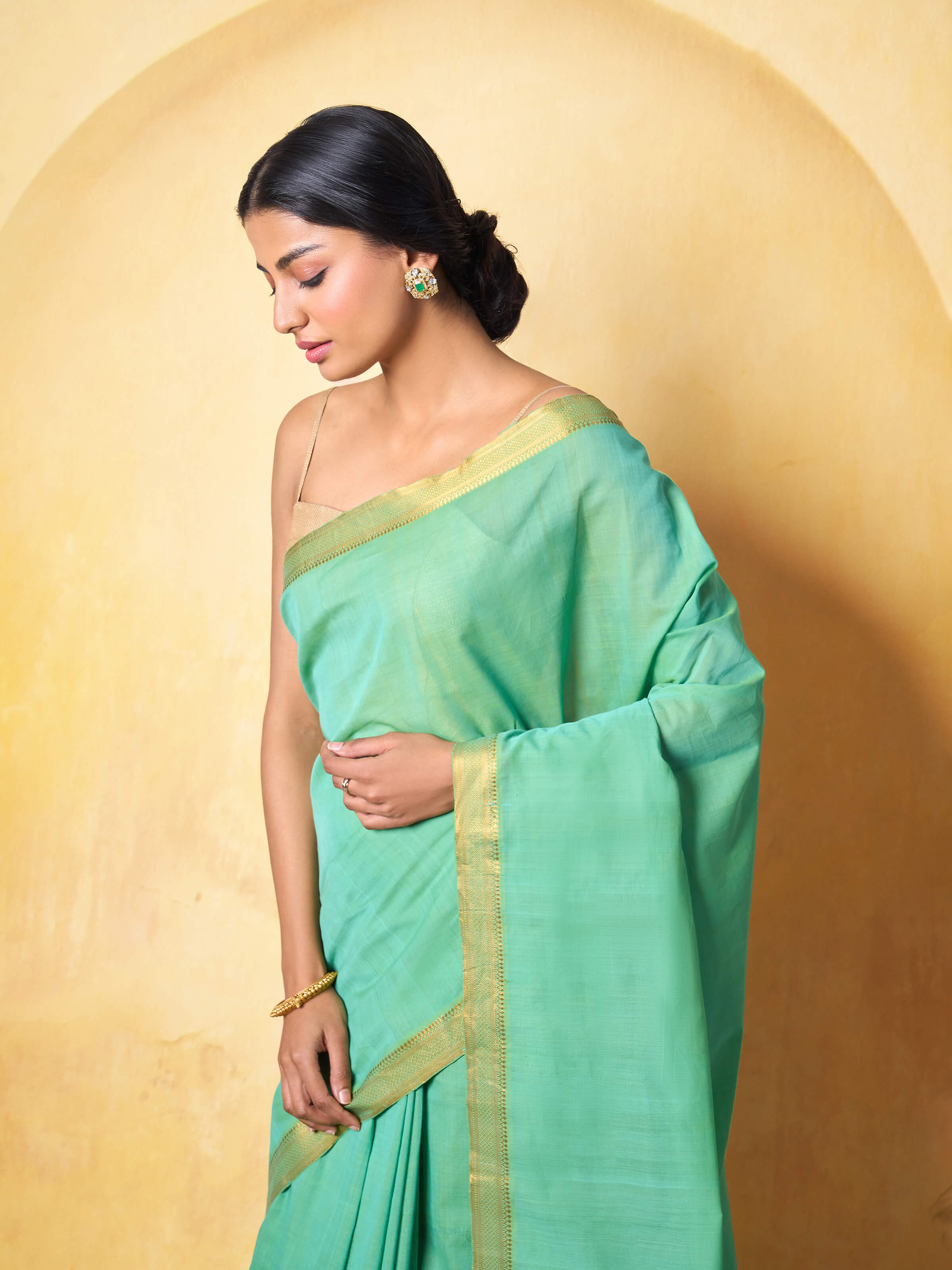 Side profile showing the smooth drape and rich border details.