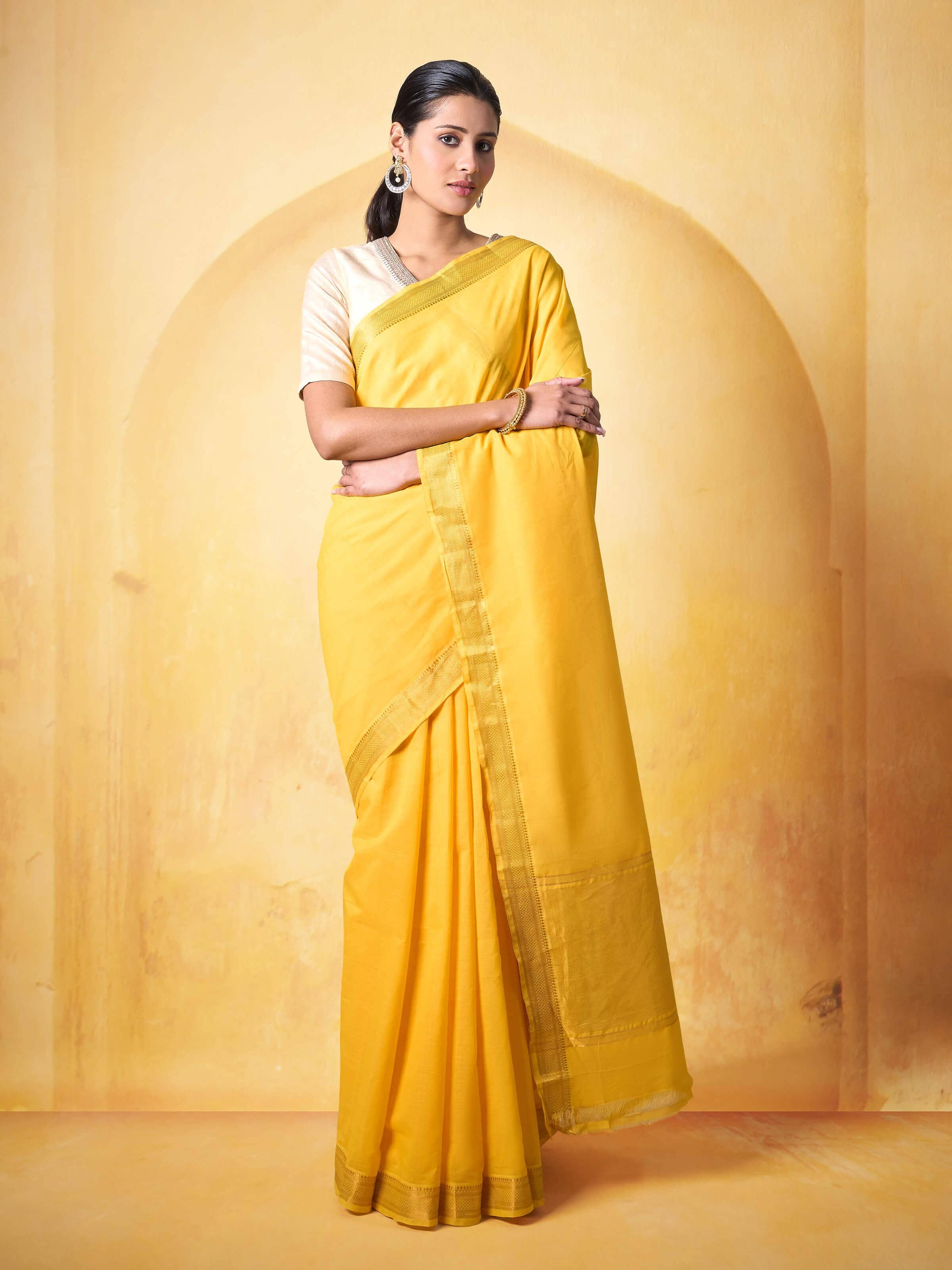 Lifestyle image of yellow Mangalgiri cotton saree draped gracefully on model
