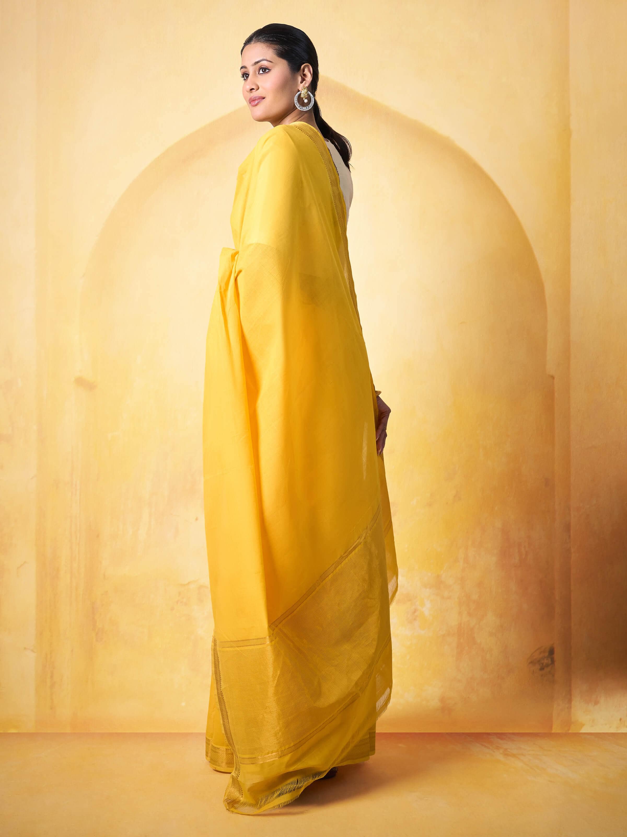 Angled shot showing fine texture and weave of yellow cotton Mangalgiri saree