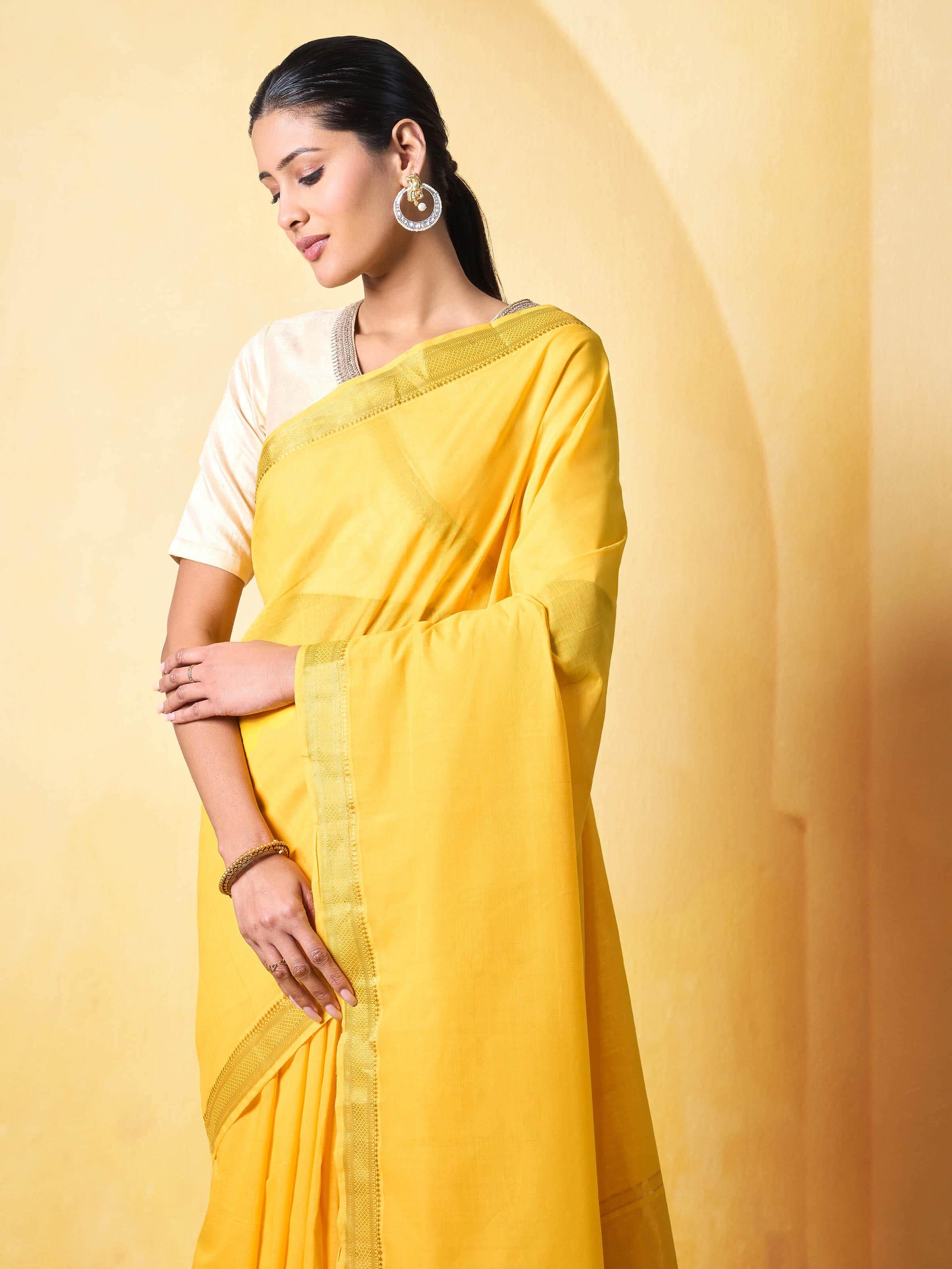 Detail shot of cotton weave and border design on yellow Mangalgiri saree