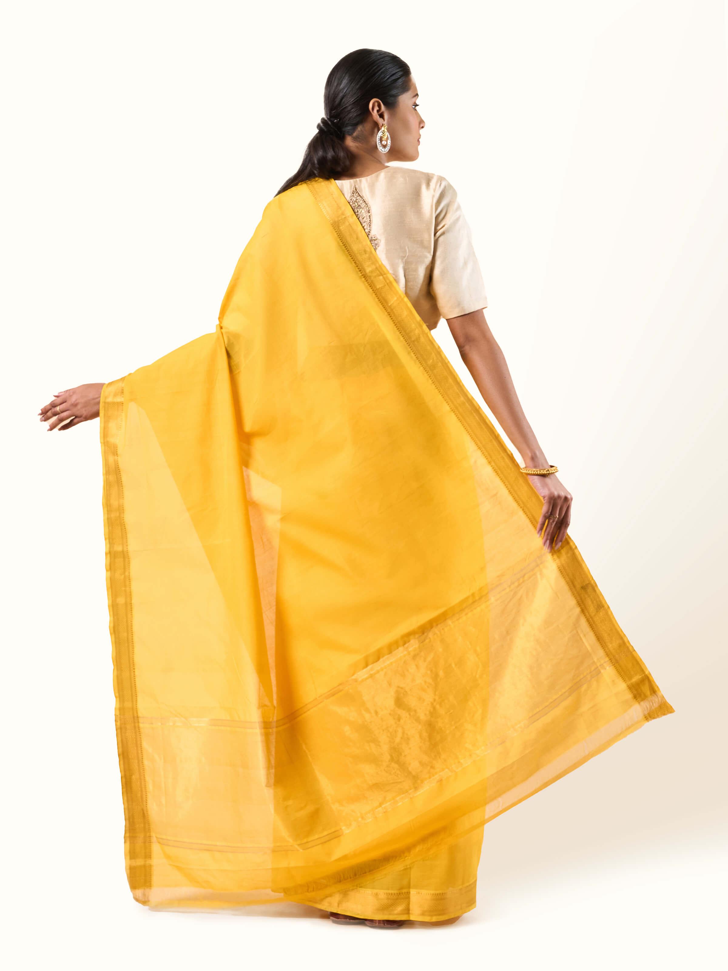 Back view of yellow cotton Mangalgiri saree showing full fabric length and border