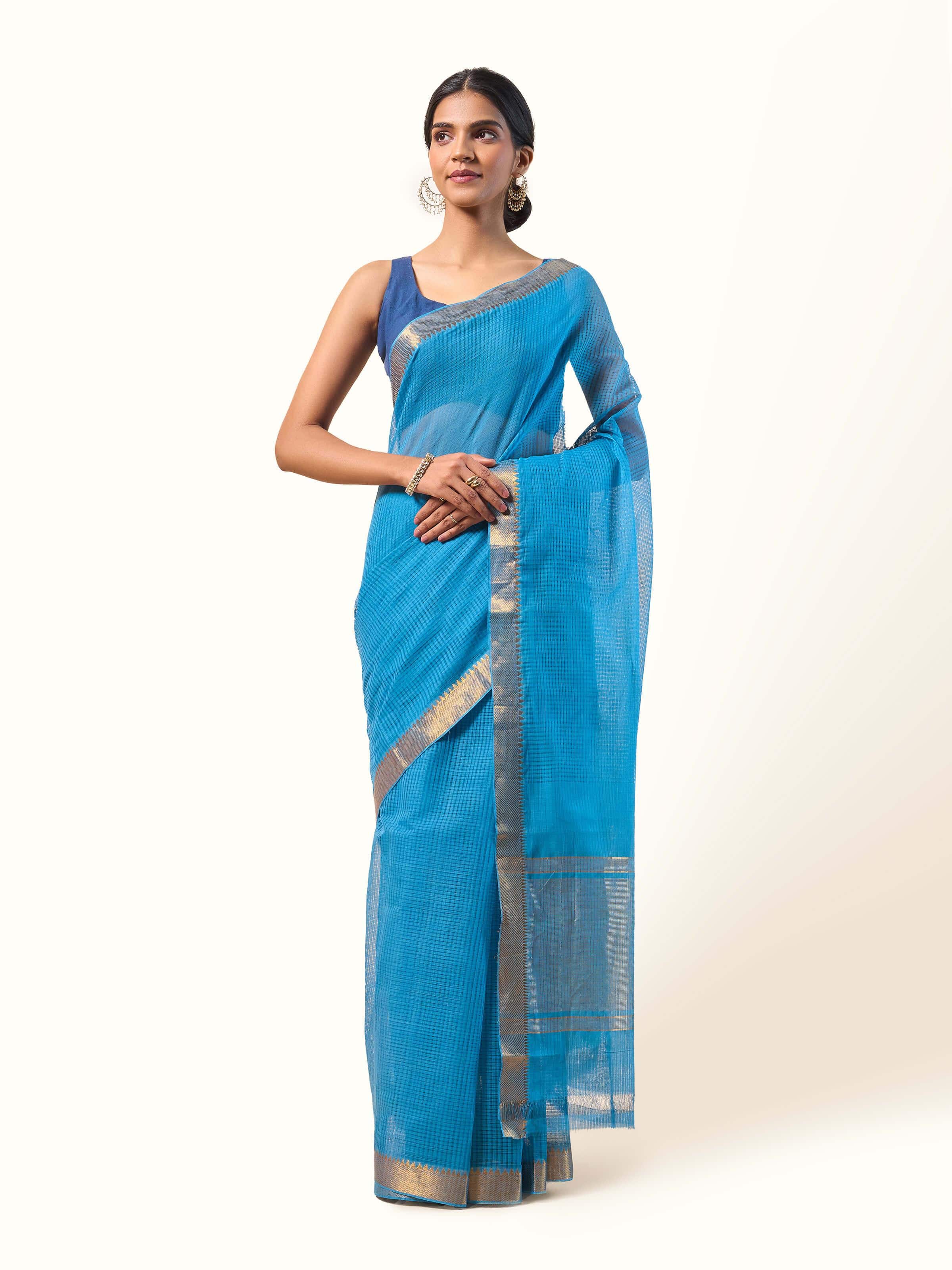 Front view of blue and gold Cotton Mangalgiri saree with golden zari border and subtle texture.