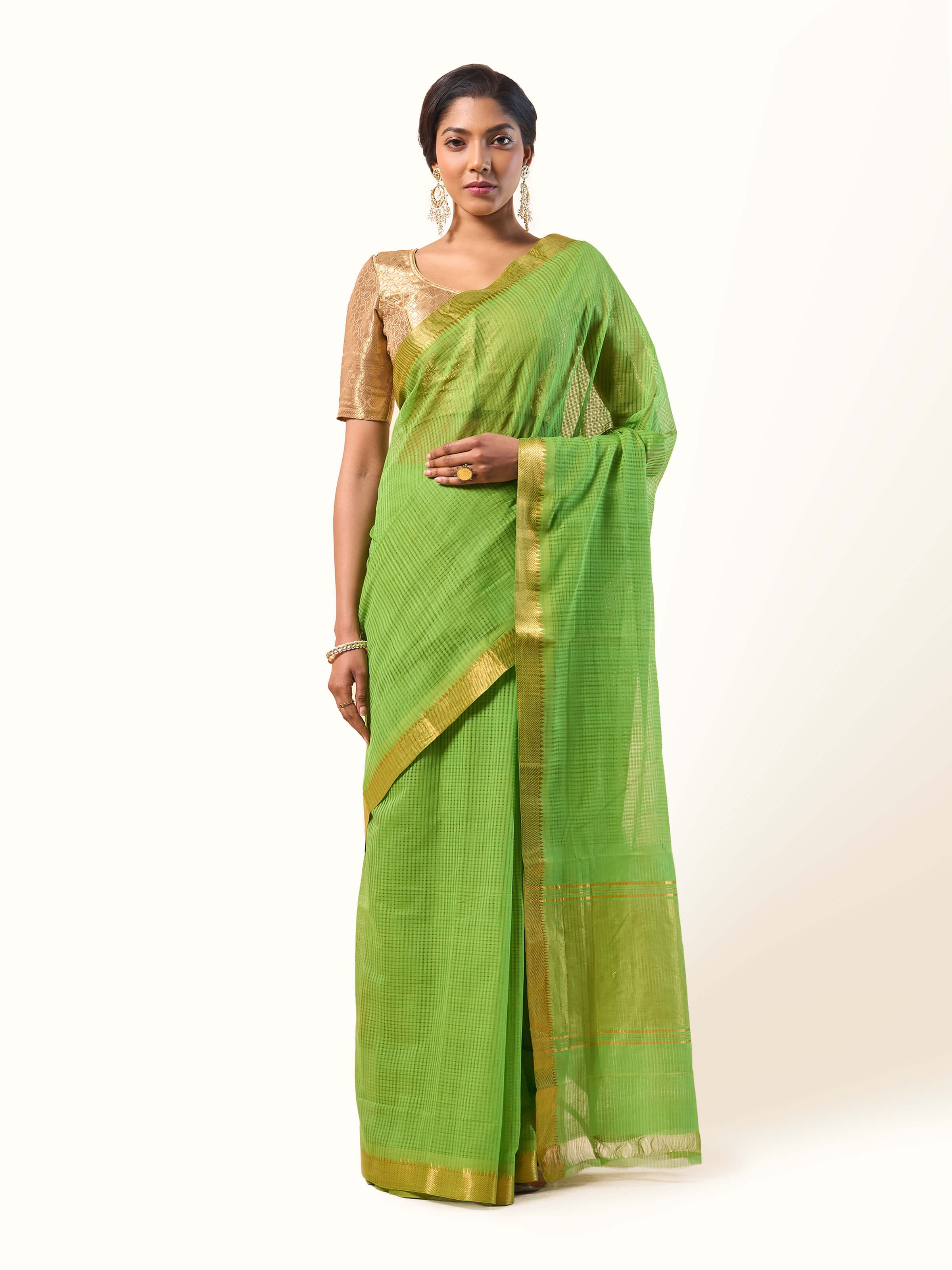 Front view of light green cotton Mangalgiri saree with a subtle striped texture and simple border.