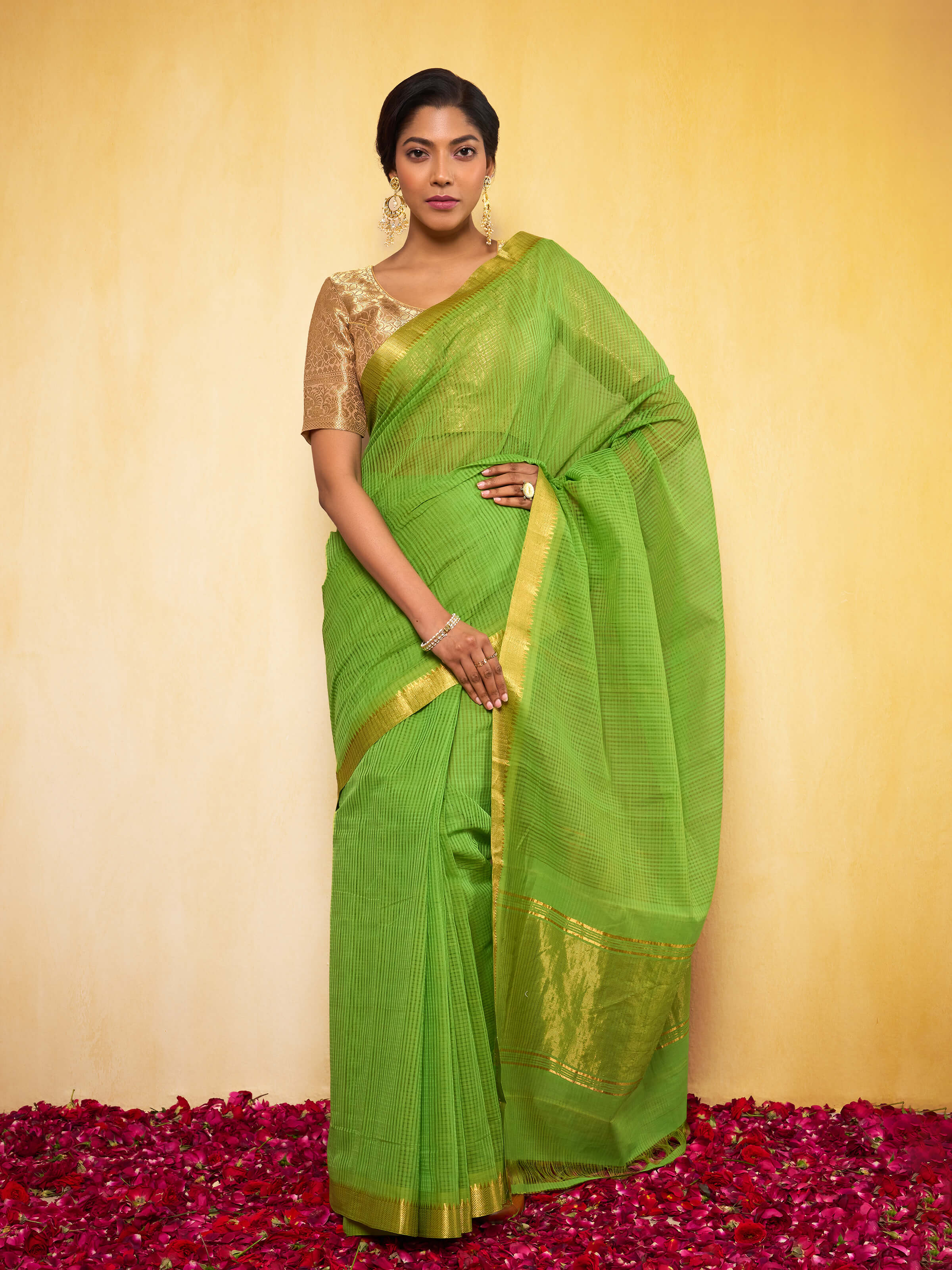 Light green Mangalgiri cotton saree draped on model showcasing its soft texture and traditional design.