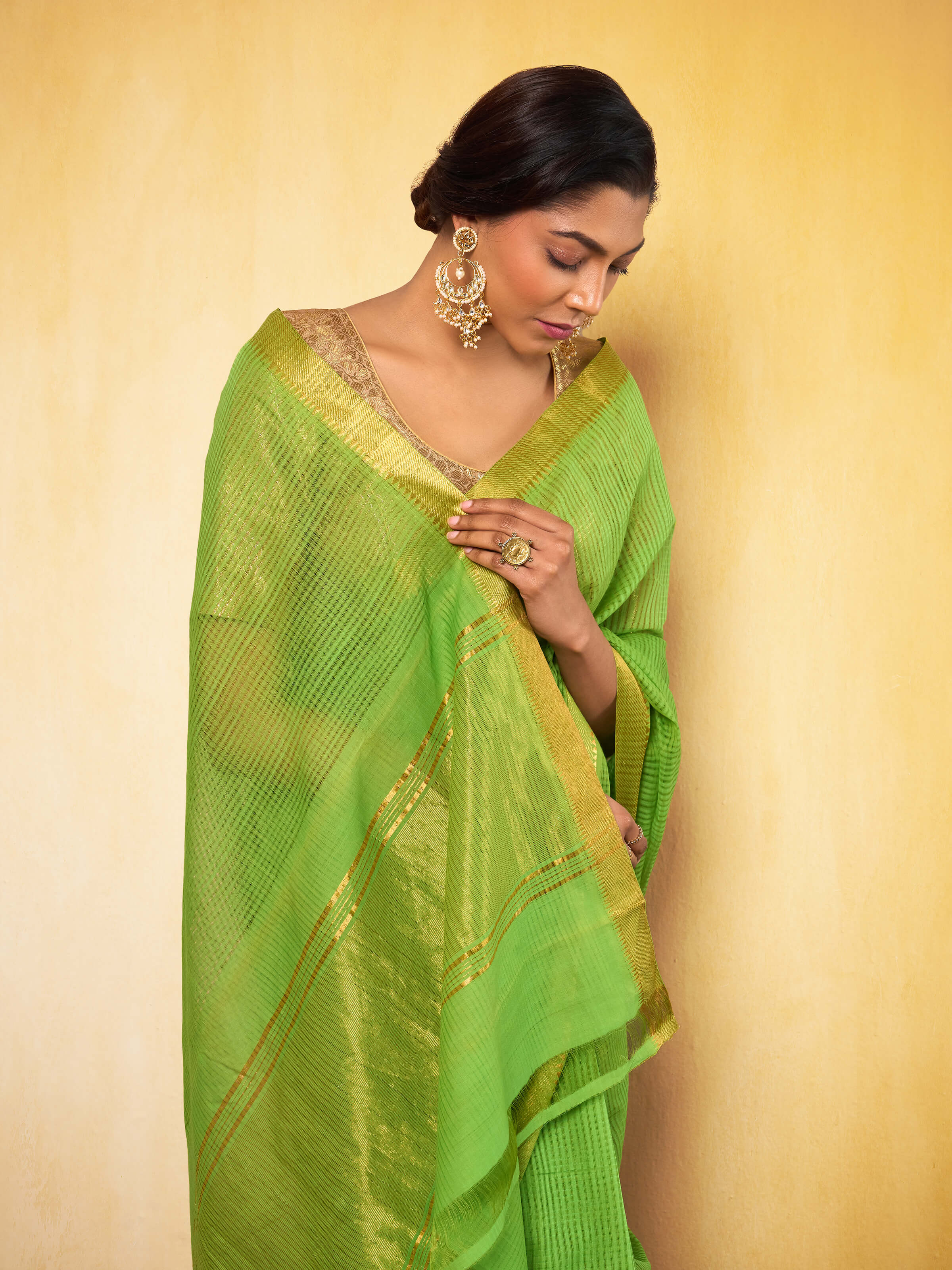 Detailed side view of light green Mangalgiri saree emphasizing its woven pattern and lightweight fabric.