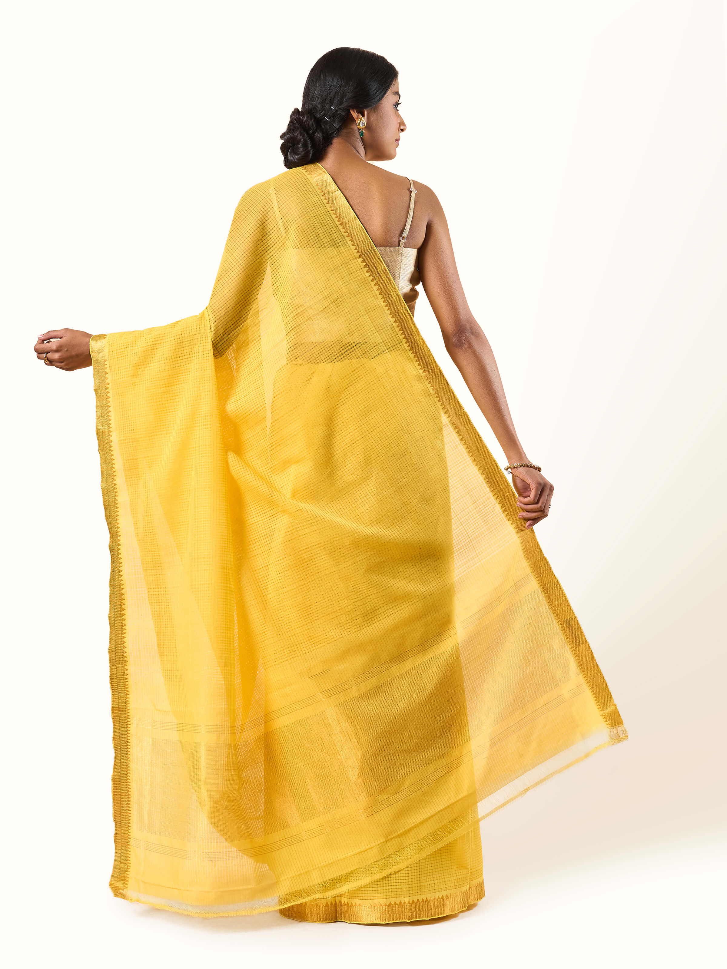 Back view of yellow and gold Mangalgiri saree showcasing fall and clean drape.