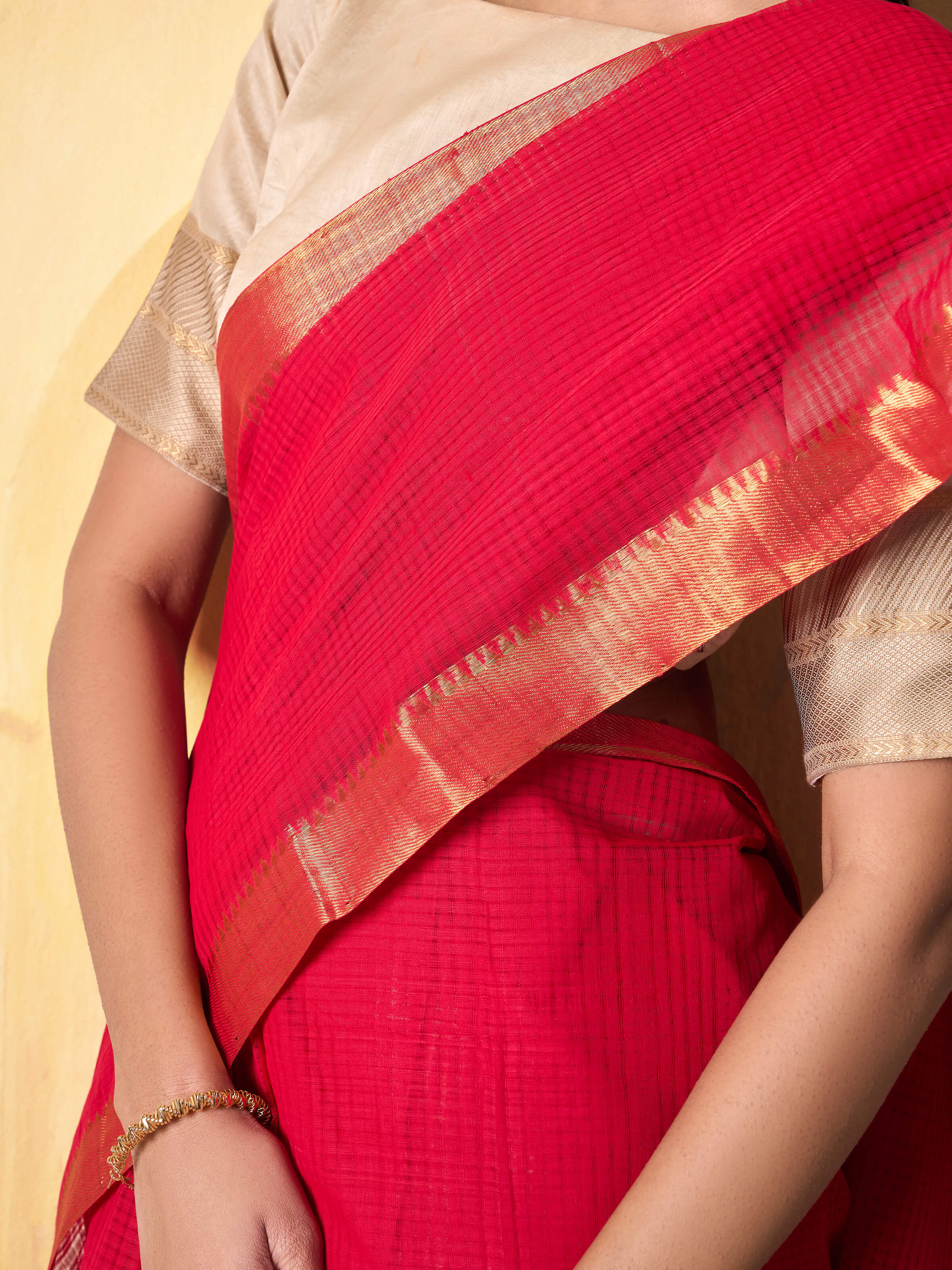 Detailed close-up of Mangalgiri cotton weave and red saree border