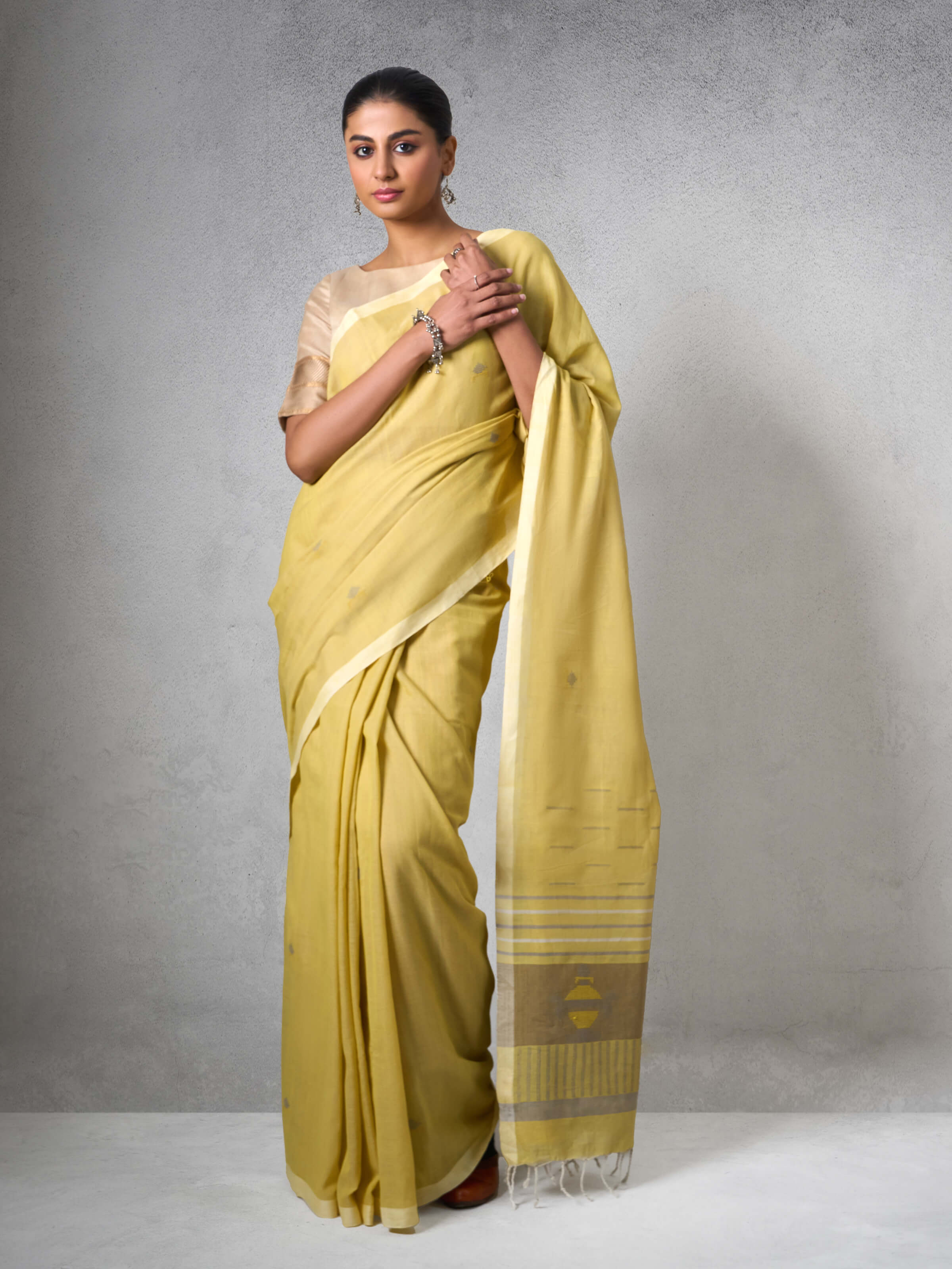Lifestyle view of Light Yellow Cotton Extra-weft Saree draped elegantly showing soft cotton fabric.