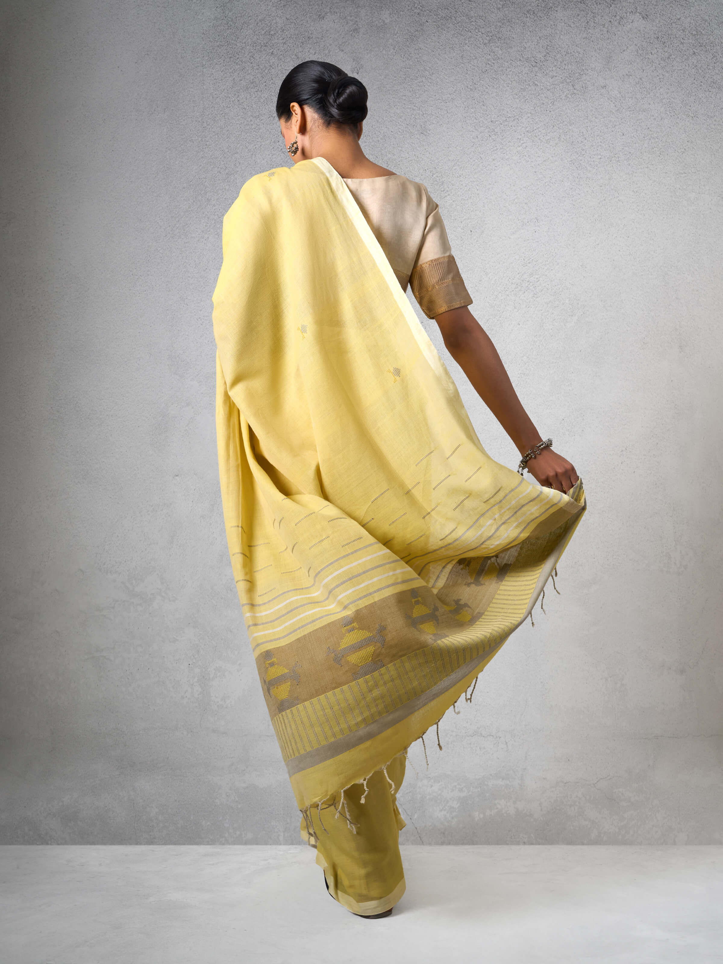 Angled view of Light Yellow Cotton Extra-weft Saree highlighting intricate extra-weft weaving detail.