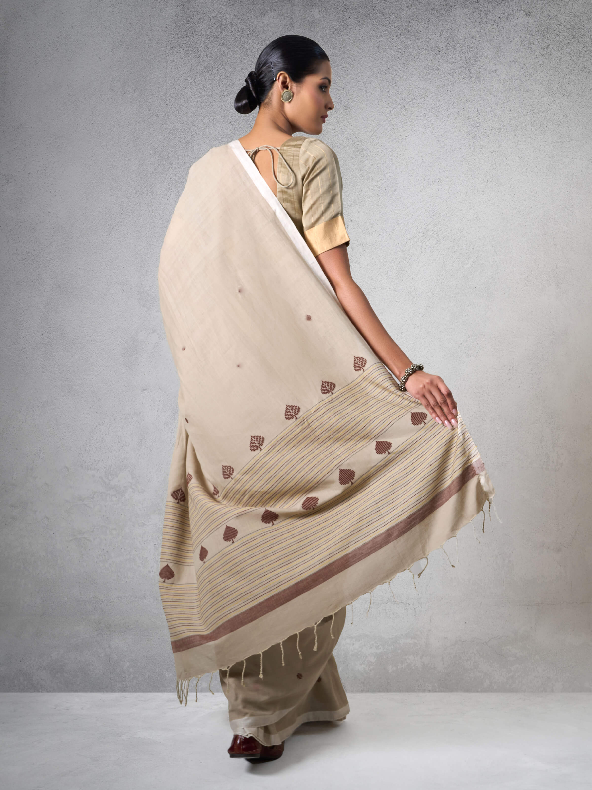 Angled view of Cotton Extra-Weft Saree displaying its texture and color variations