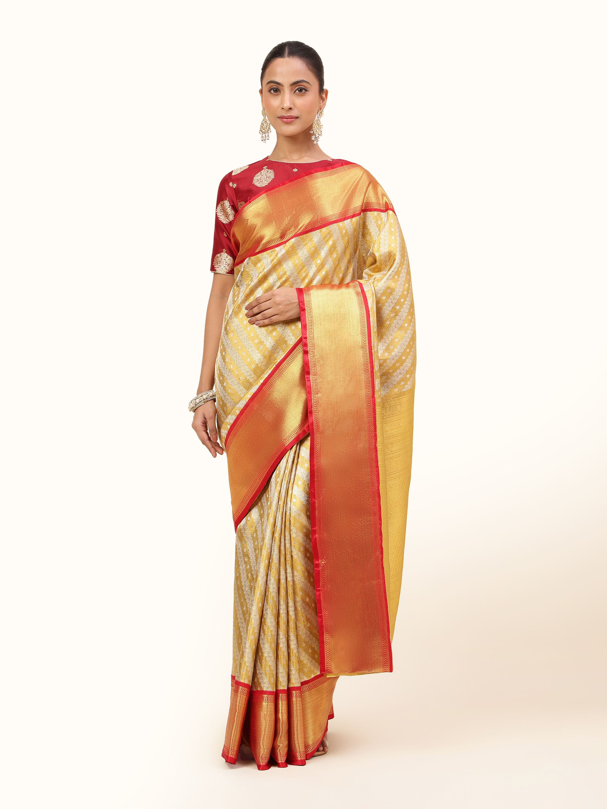 Front view of gold silk Kancheepuram saree with traditional motifs and sheen.