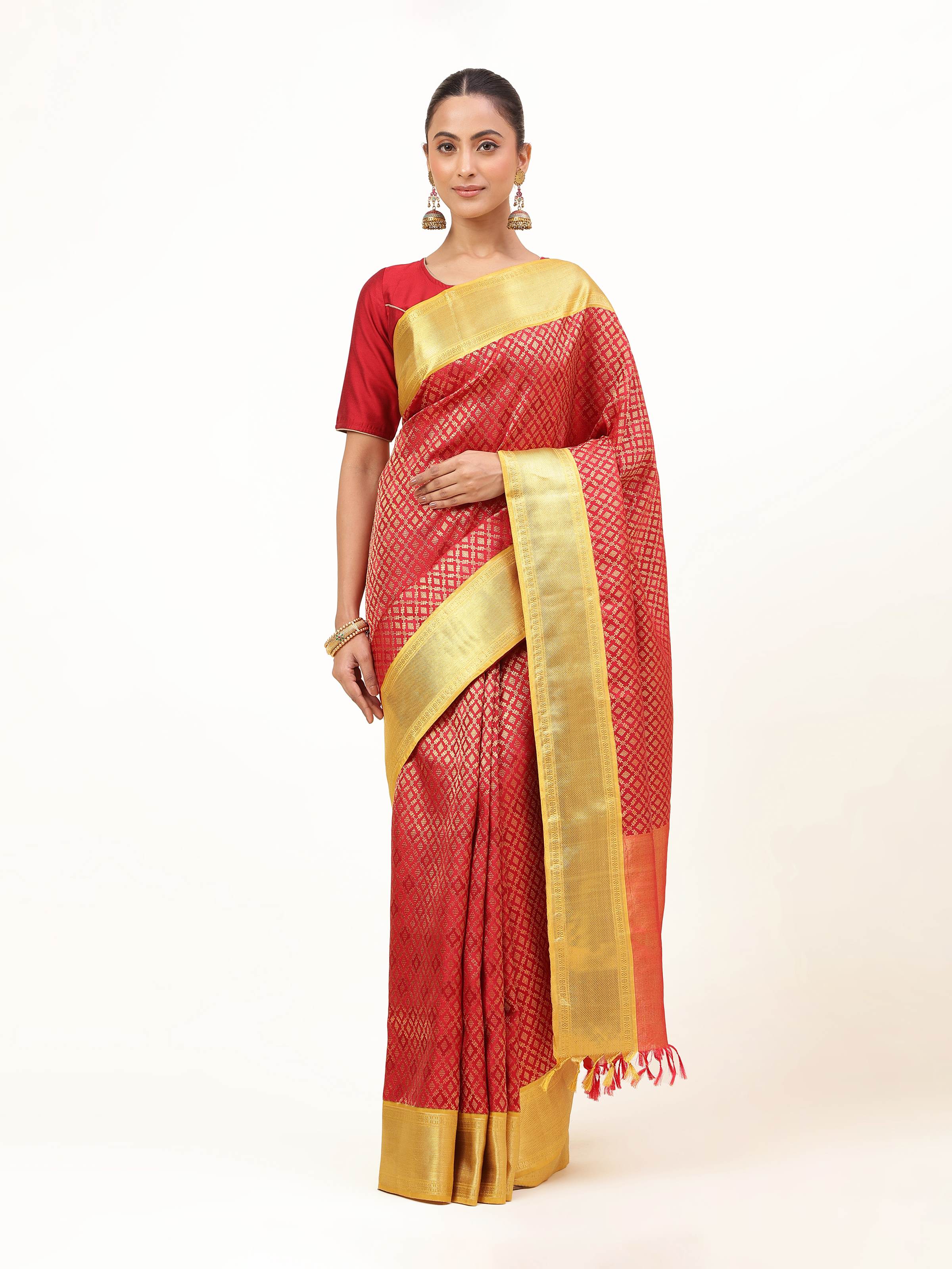 Front view of traditional red Kancheepuram silk saree with gold zari border and intricate pallu design.