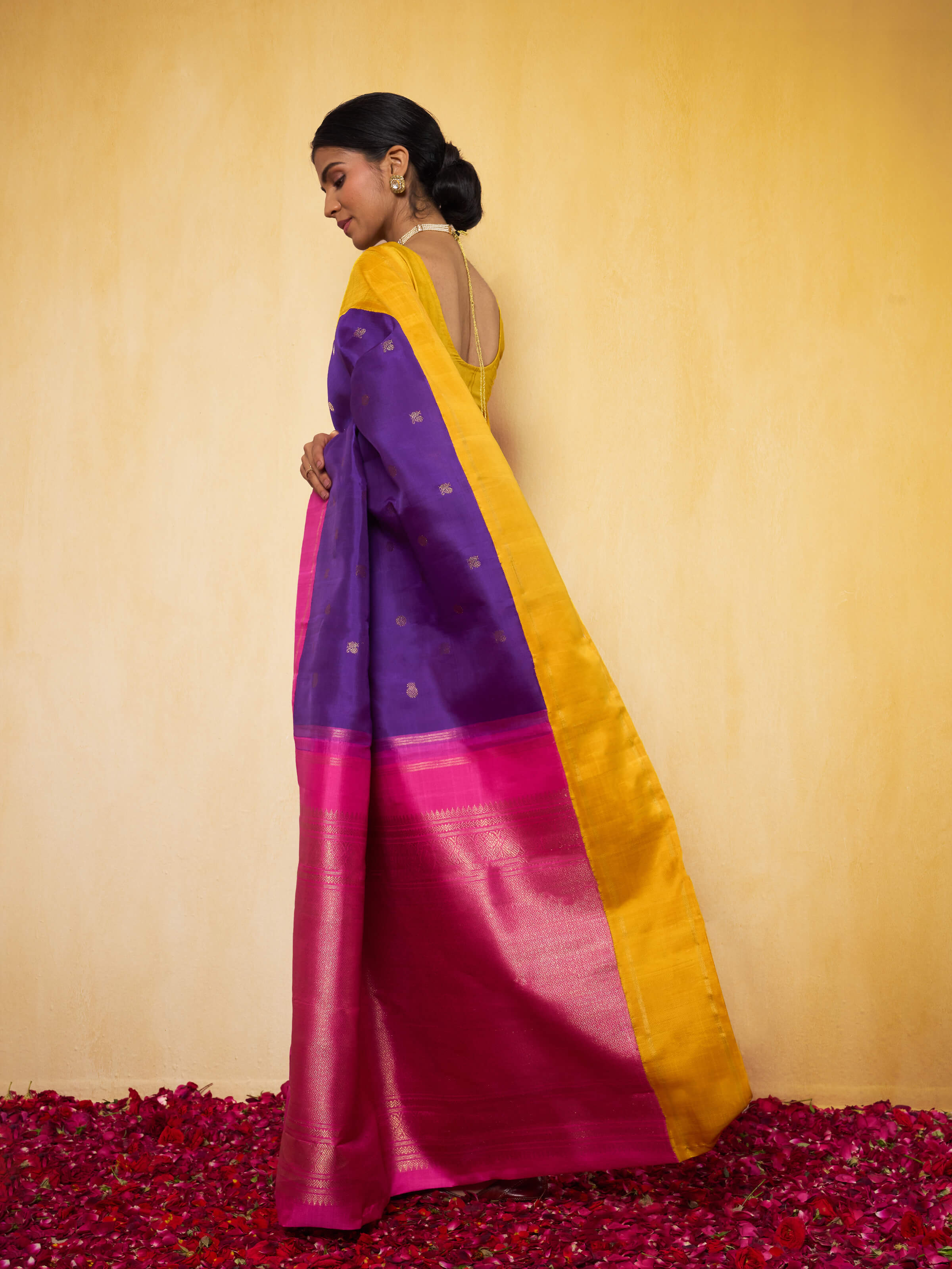 Angled view highlighting silk texture and intricate zari work on saree border