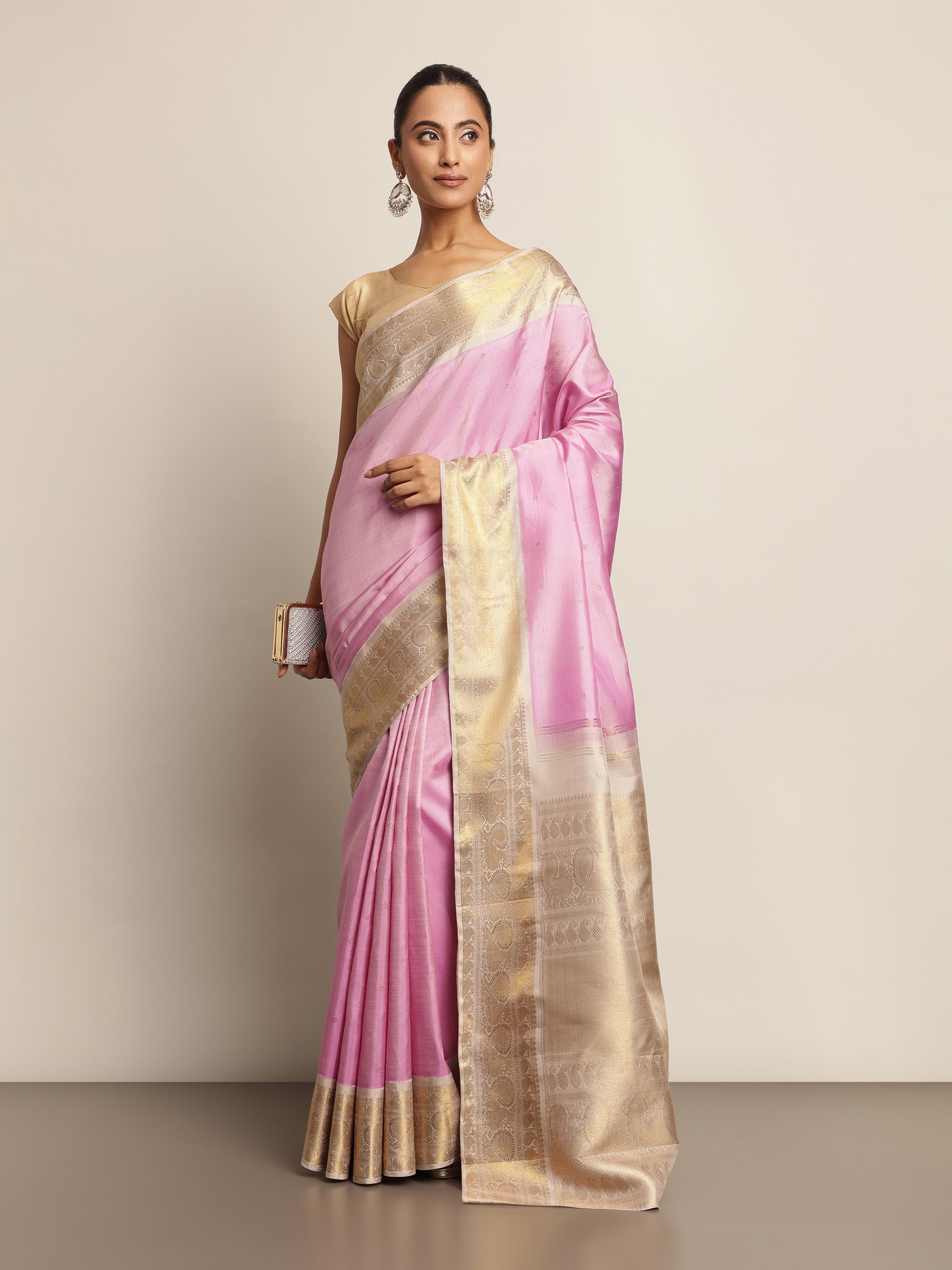 Model draped in pink Kancheepuram silk saree in festive pose