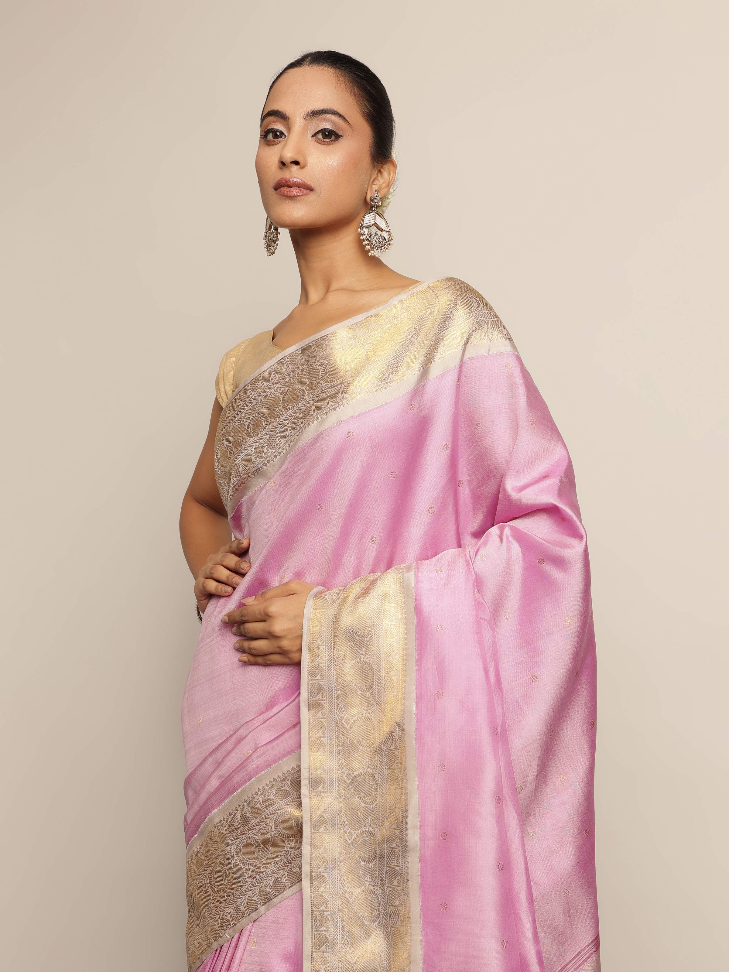 Detailed texture of silk fabric and zari work on pink saree