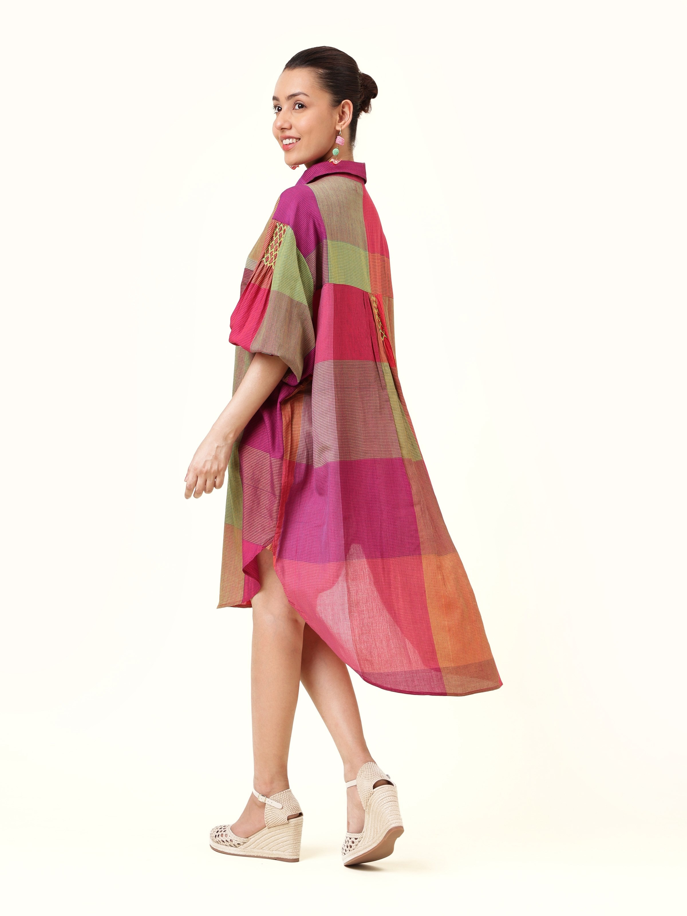 Back view revealing the harmonious weave and fluid drape, offering a versatile piece for many occasions.