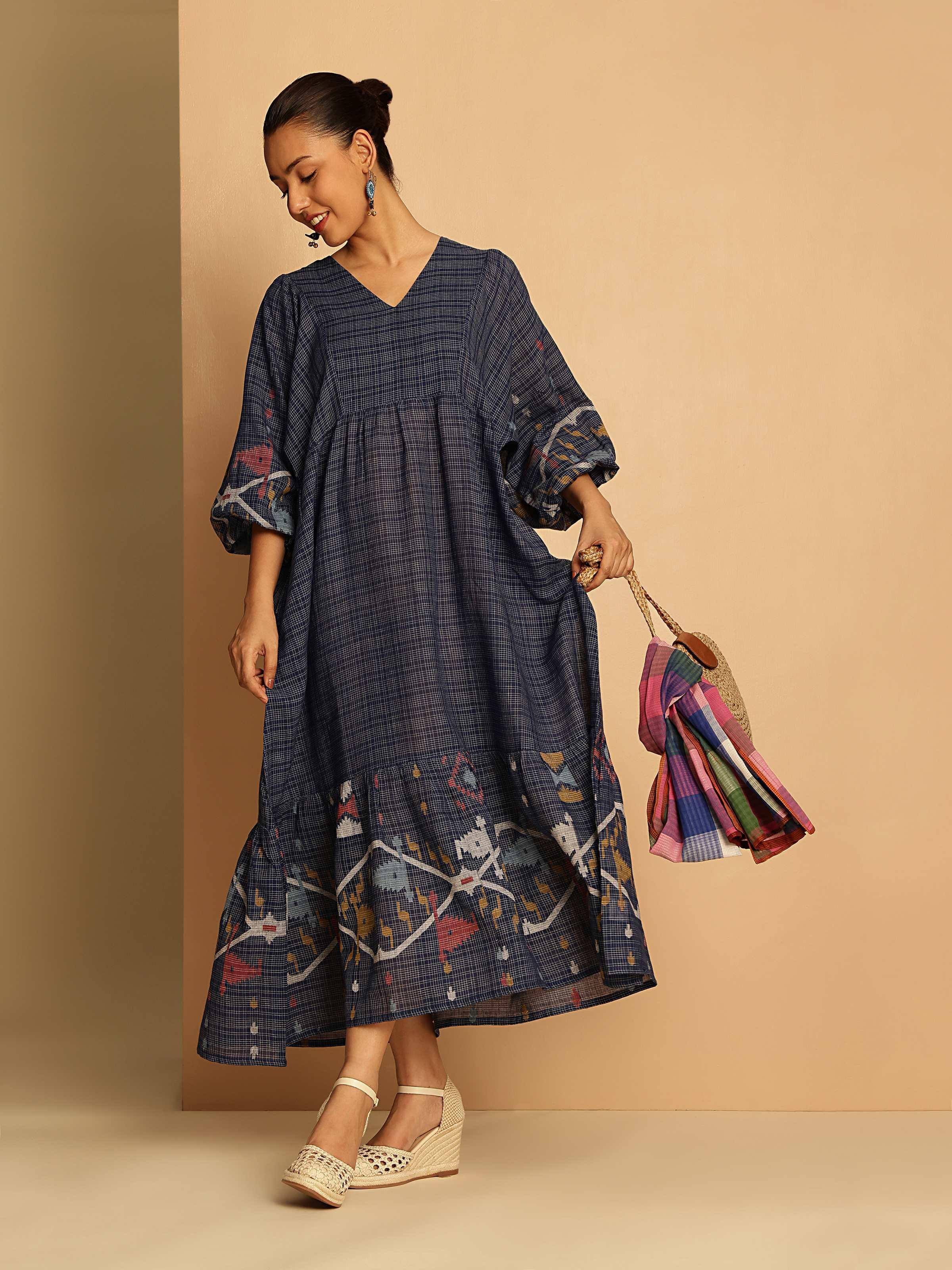 Lifestyle image of blue cotton Jamdani dress worn casually, highlighting flowy sleeves