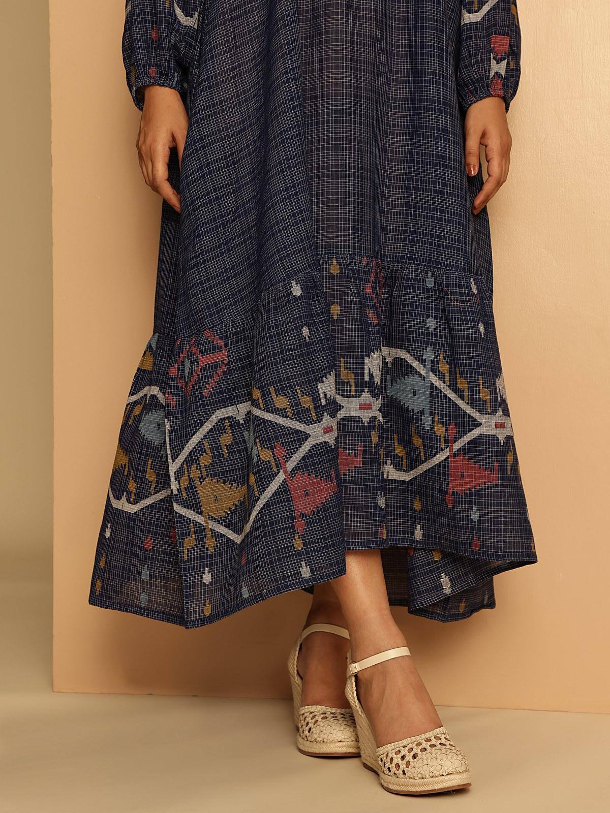 Detailed close-up of Jamdani motifs on blue cotton dress sleeves and body