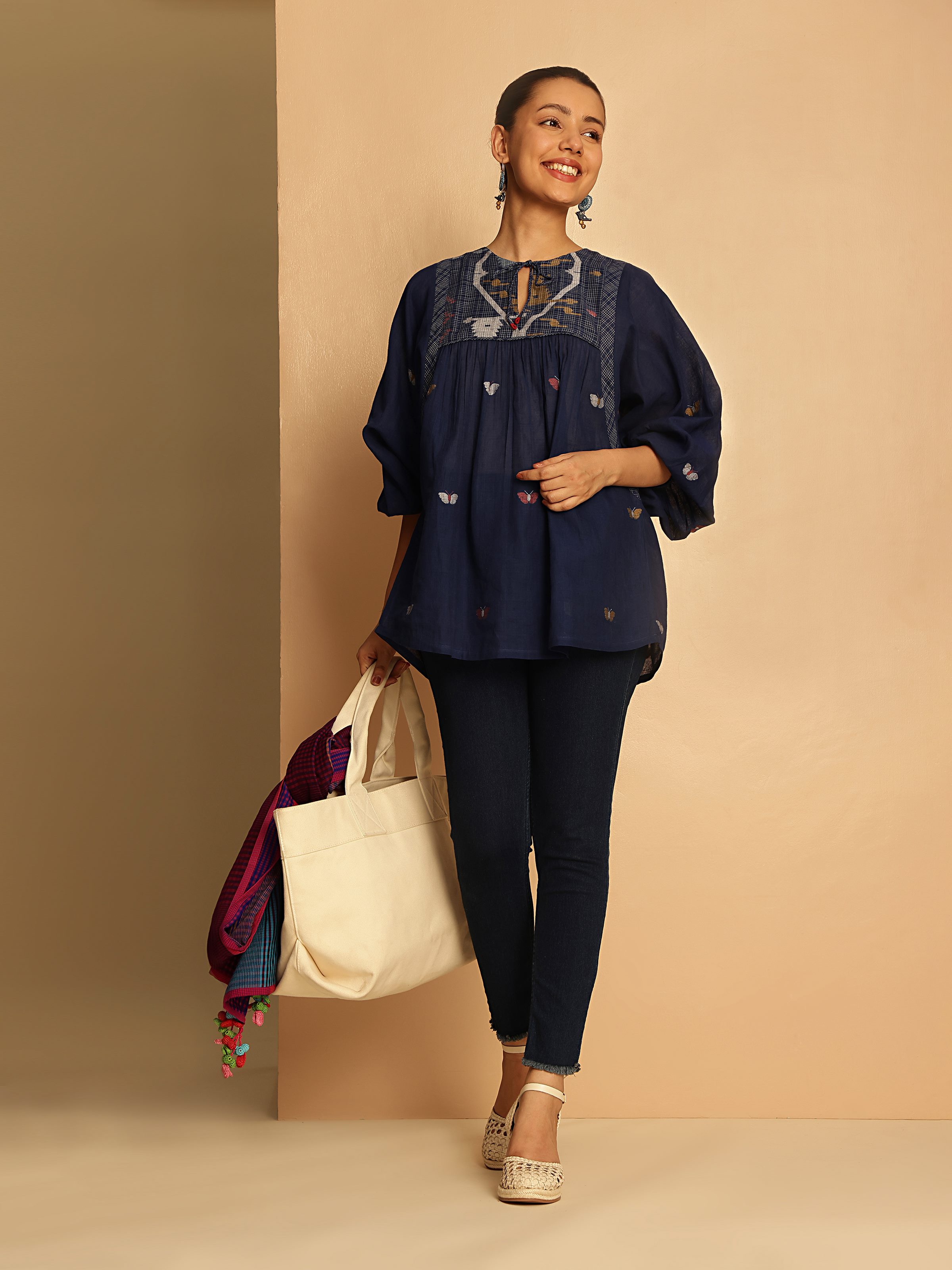 Model wearing blue Bengal Jamdani cotton top styled in a relaxed bohemian look.