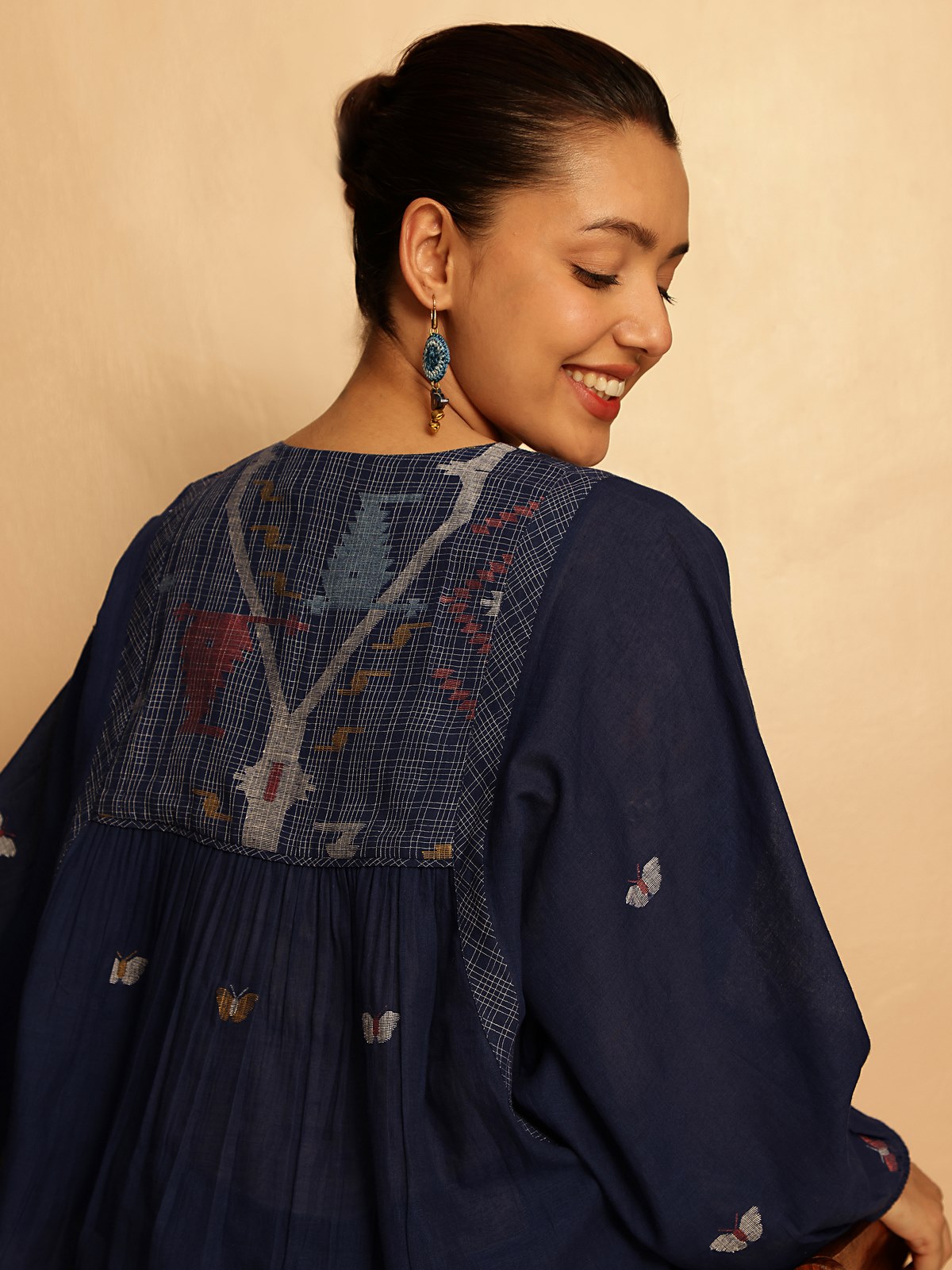 Model walking in blue Jamdani cotton top showing fluid fit and handcrafted texture.