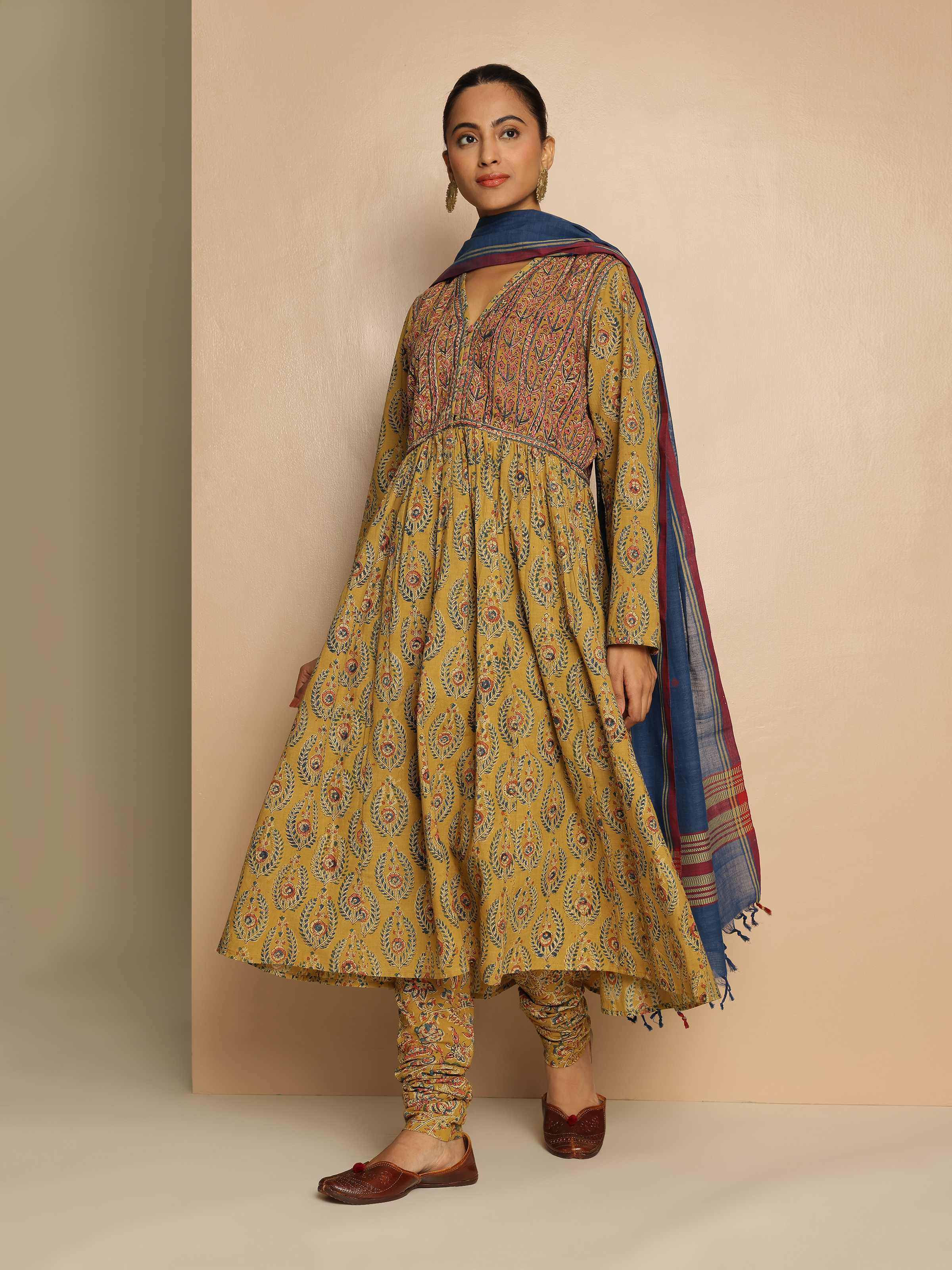 Detailed front view of Model wearing yellow Kalamkari printed cotton kurta styled for a casual ethnic look.