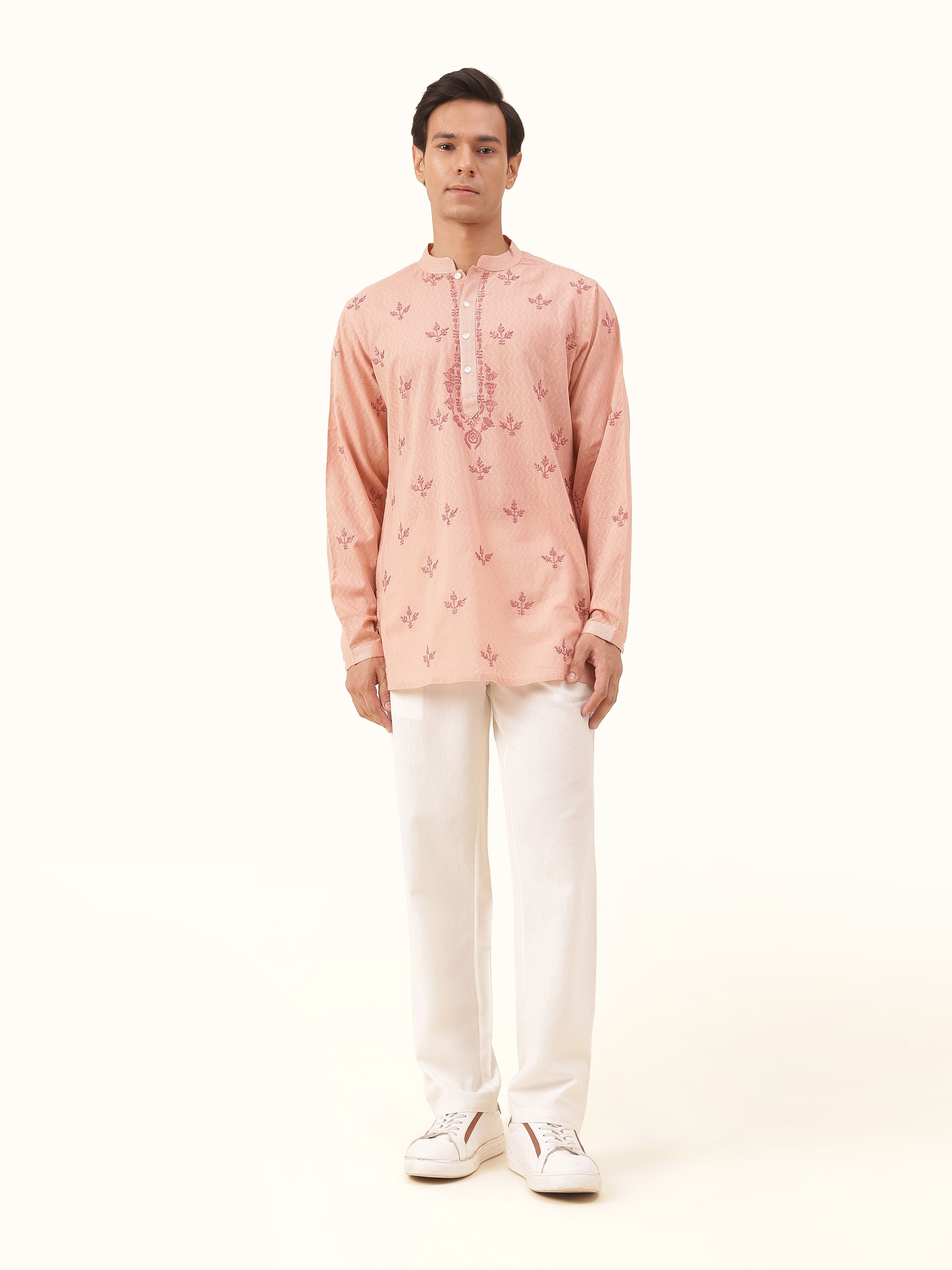 Front view of the pink cotton Chikankari short kurta, showcasing its soft texture and intricate embroidery details.