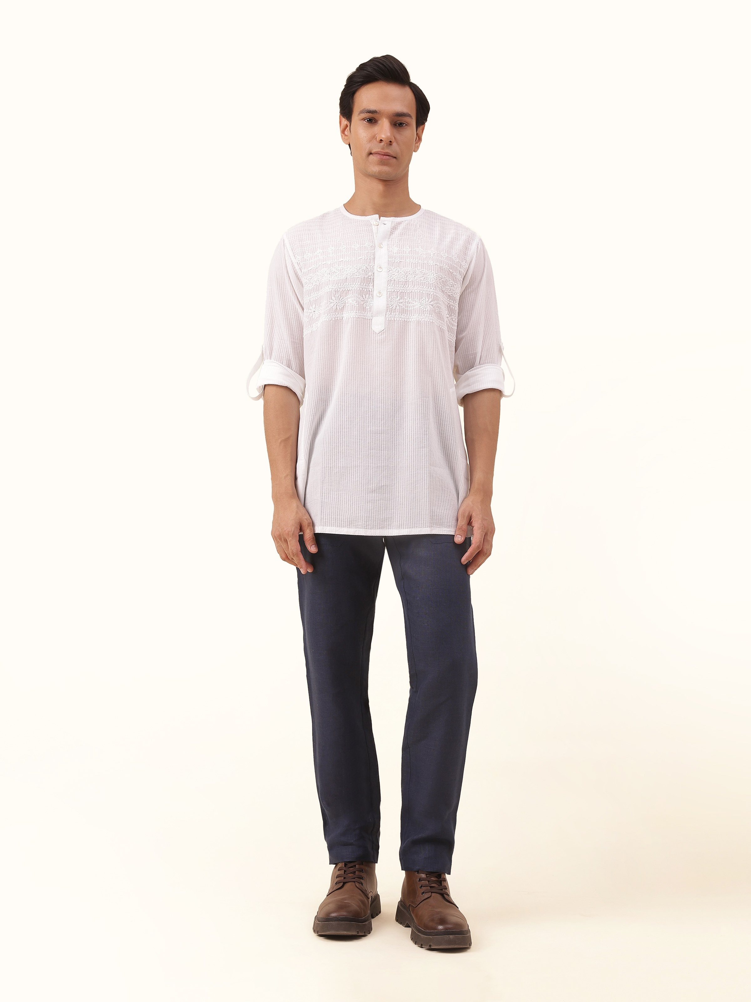 Front view of white cotton chikankari short kurta featuring delicate embroidery and mandarin collar