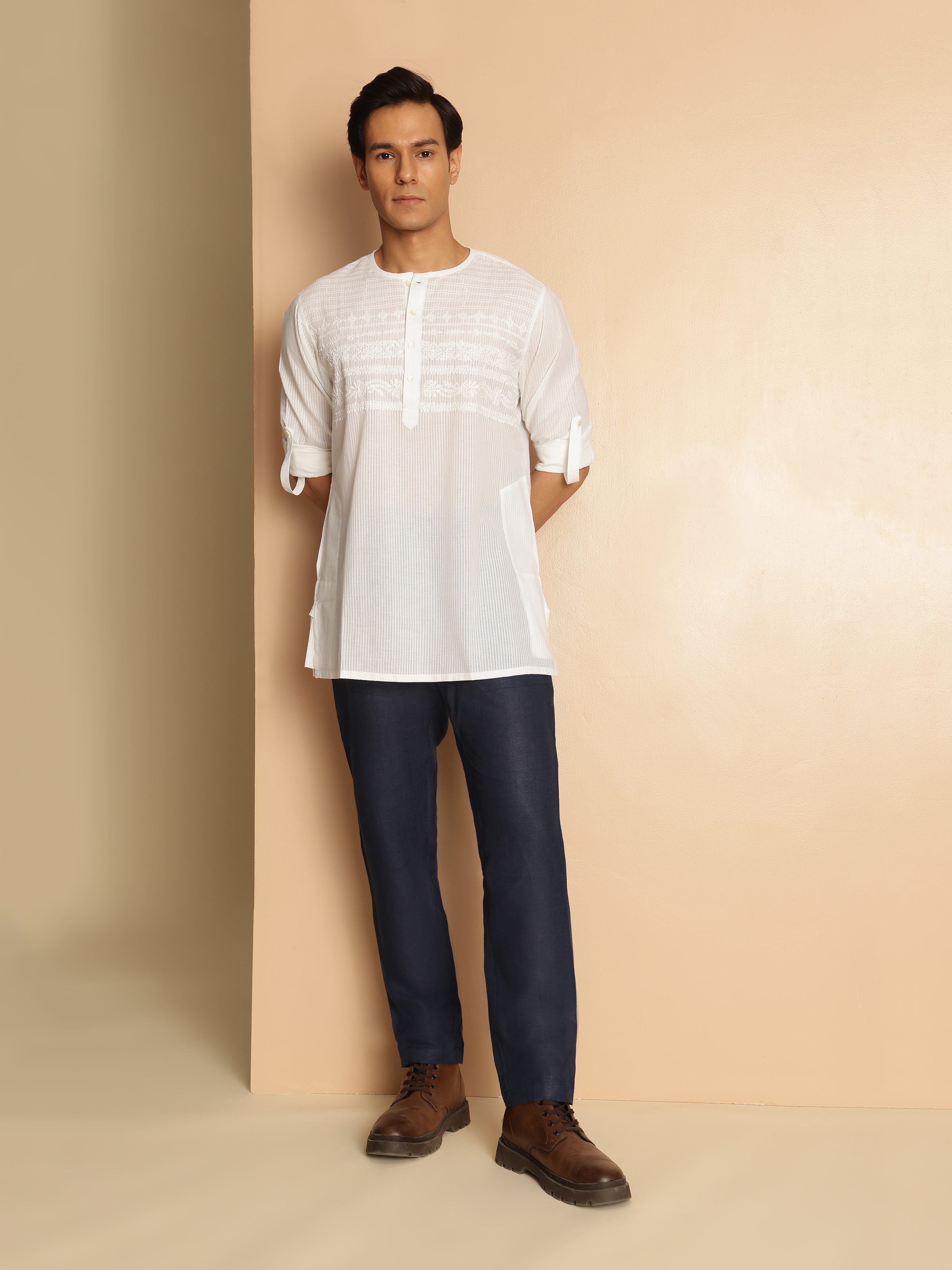 Lifestyle view of white chikankari short kurta styled with pants for a casual ethnic look