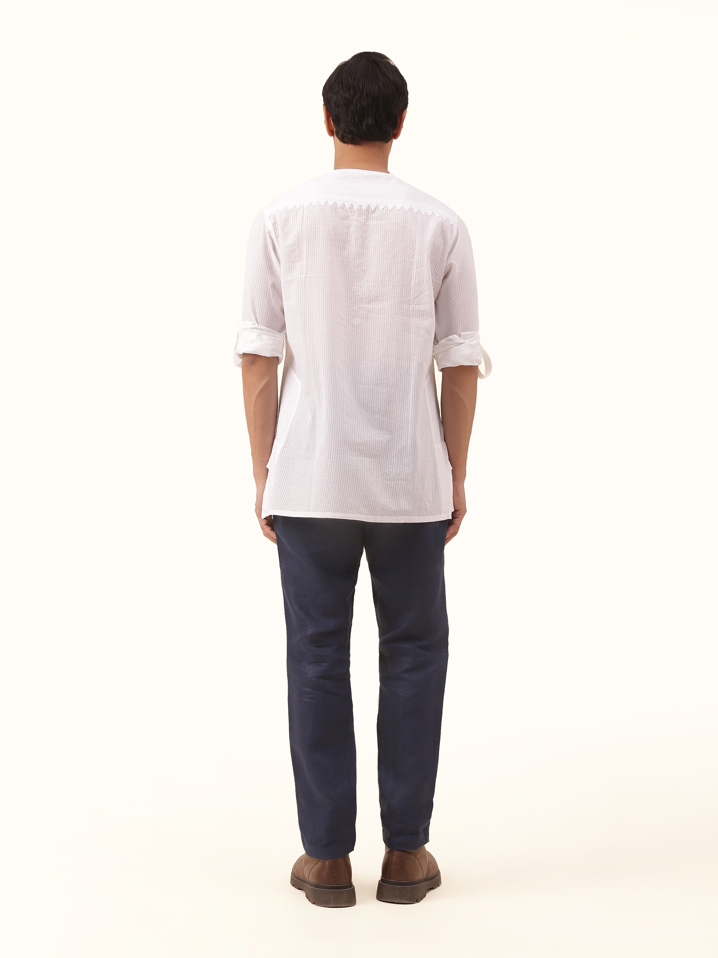 Back view of white cotton chikankari kurta displaying straight hem and clean finish