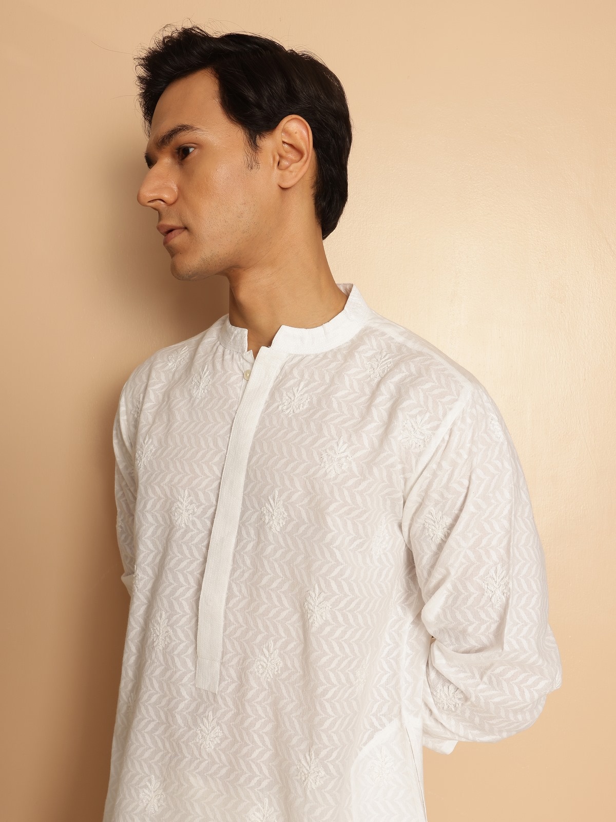 Another angle capturing the delicate hand embroidery and fine stitch details that define this piece.