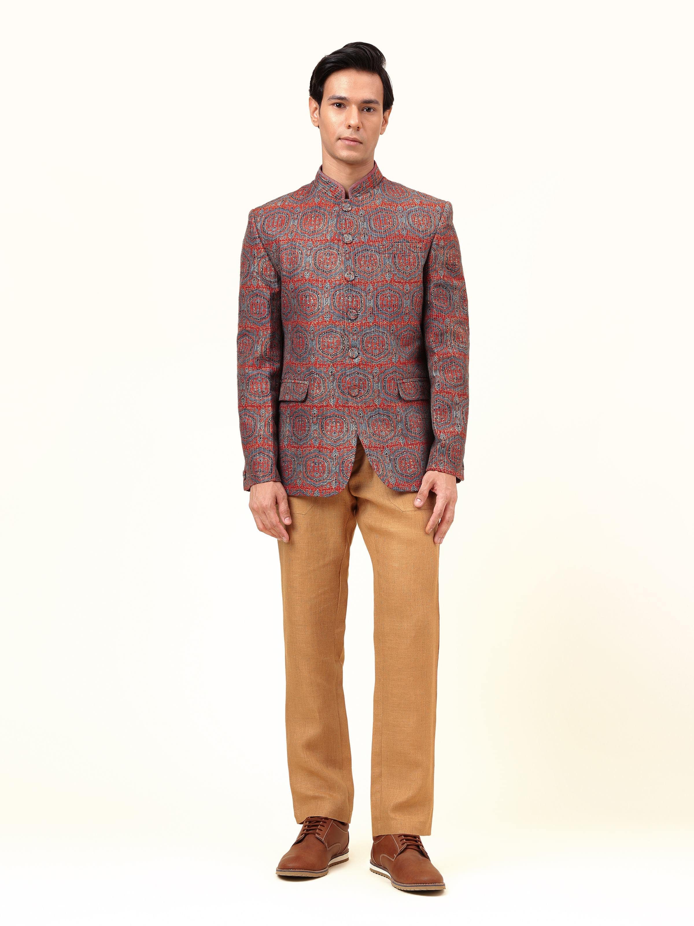 Lifestyle view of indigo silk Ajrakh block printed Bandhgala jacket styled with white kurta and trousers