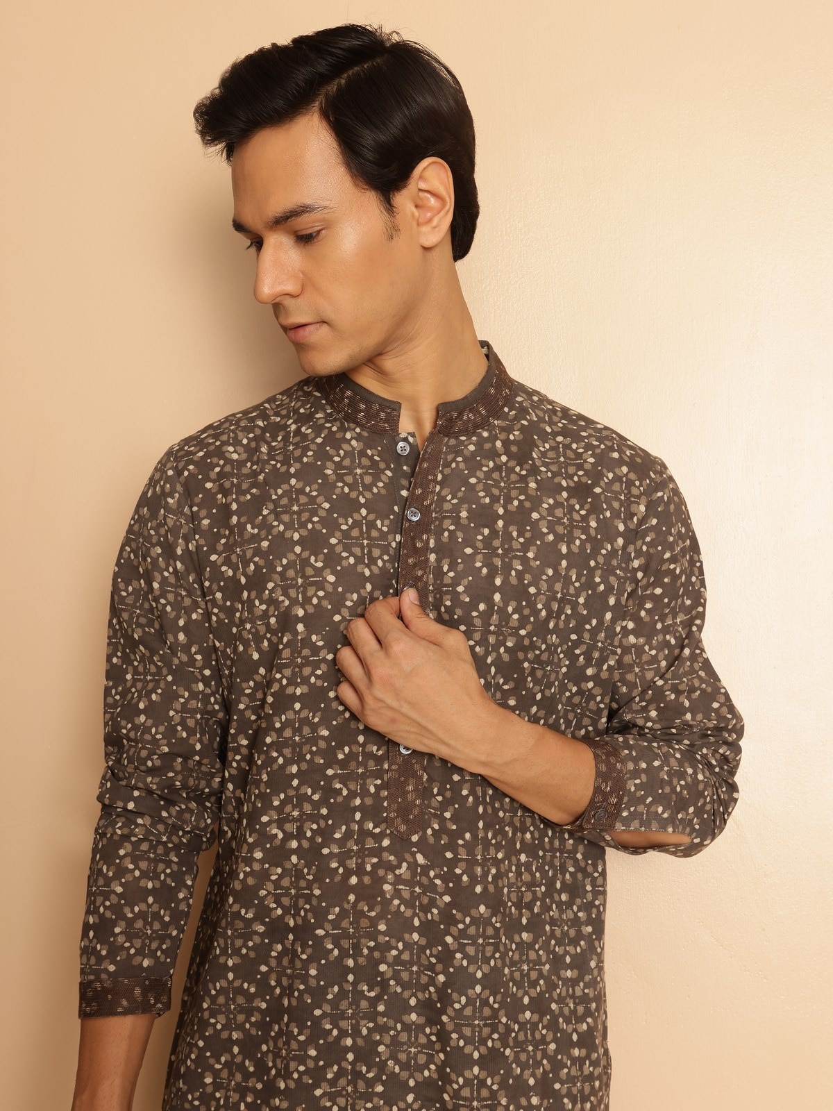 Side pose of model in grey Dabu printed cotton kurta highlighting the relaxed fit and sleeve detailing.